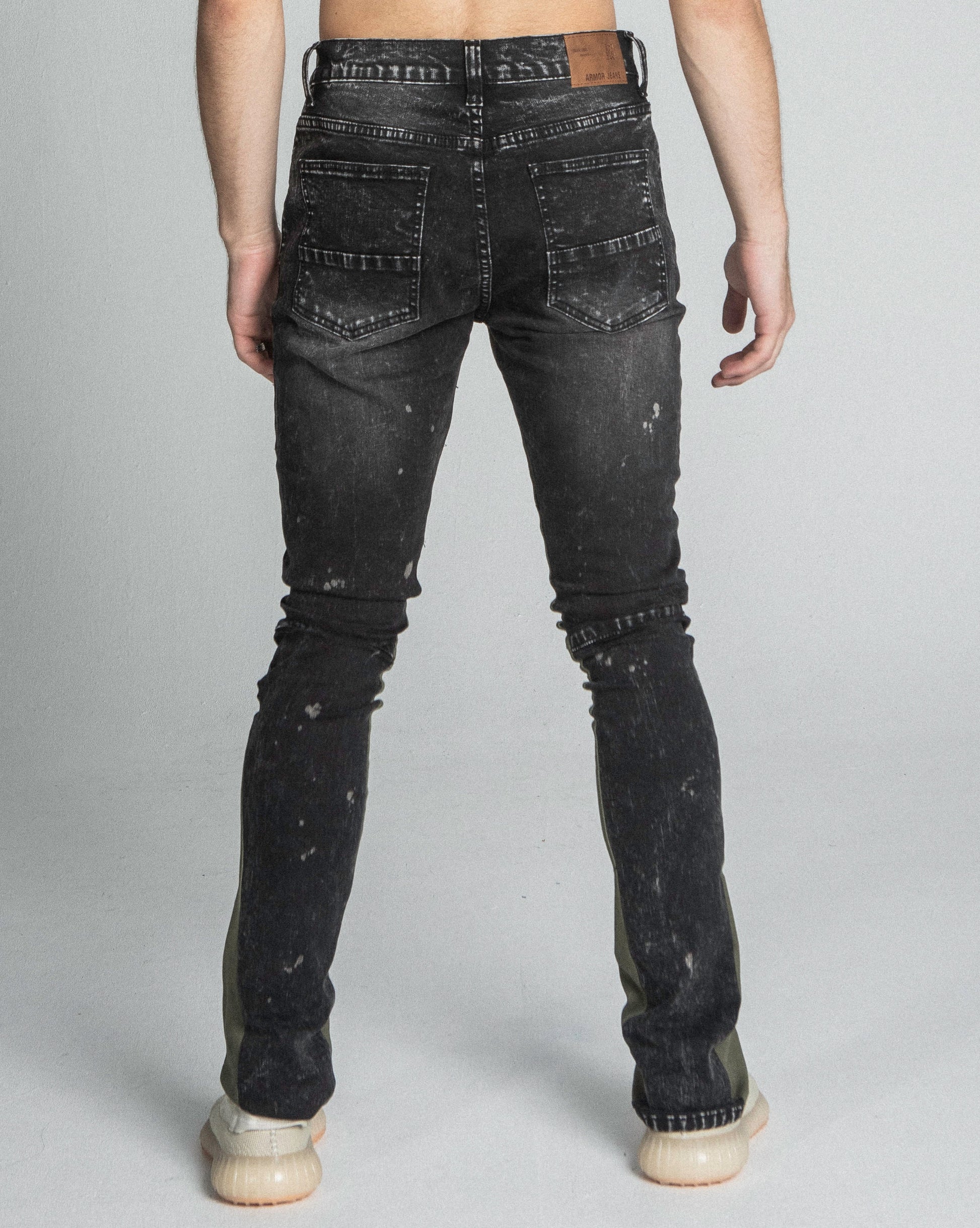 Back view of AR711 BLACK/BROWM DISTRESSED STAR STACKED JEANS with a mid-rise waist and five-pocket design, made from stretchy cotton.