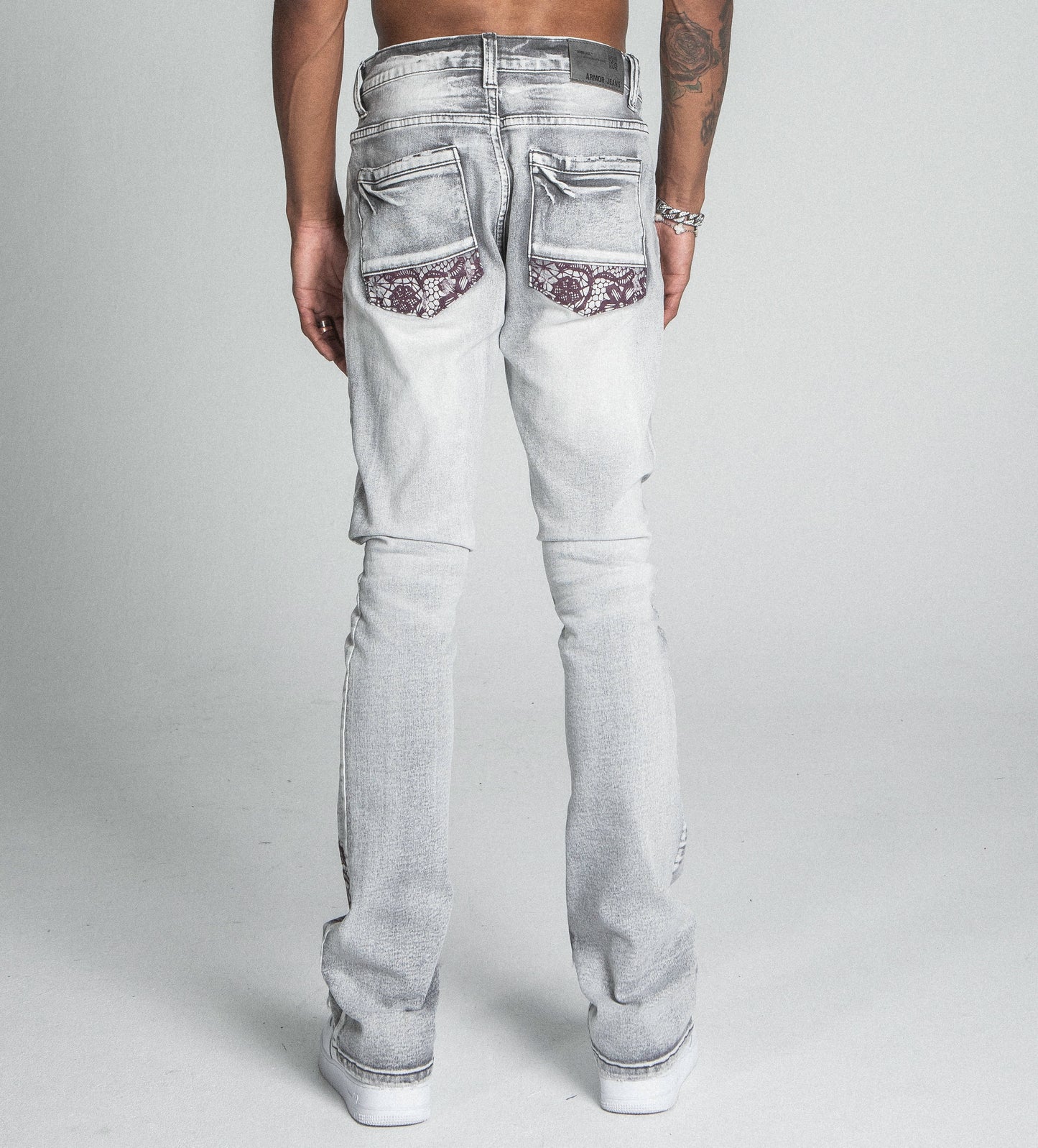 AJ27SK LACE FADED WASH STACKED JEANS with lace detailing and five-pocket design shown from the back view