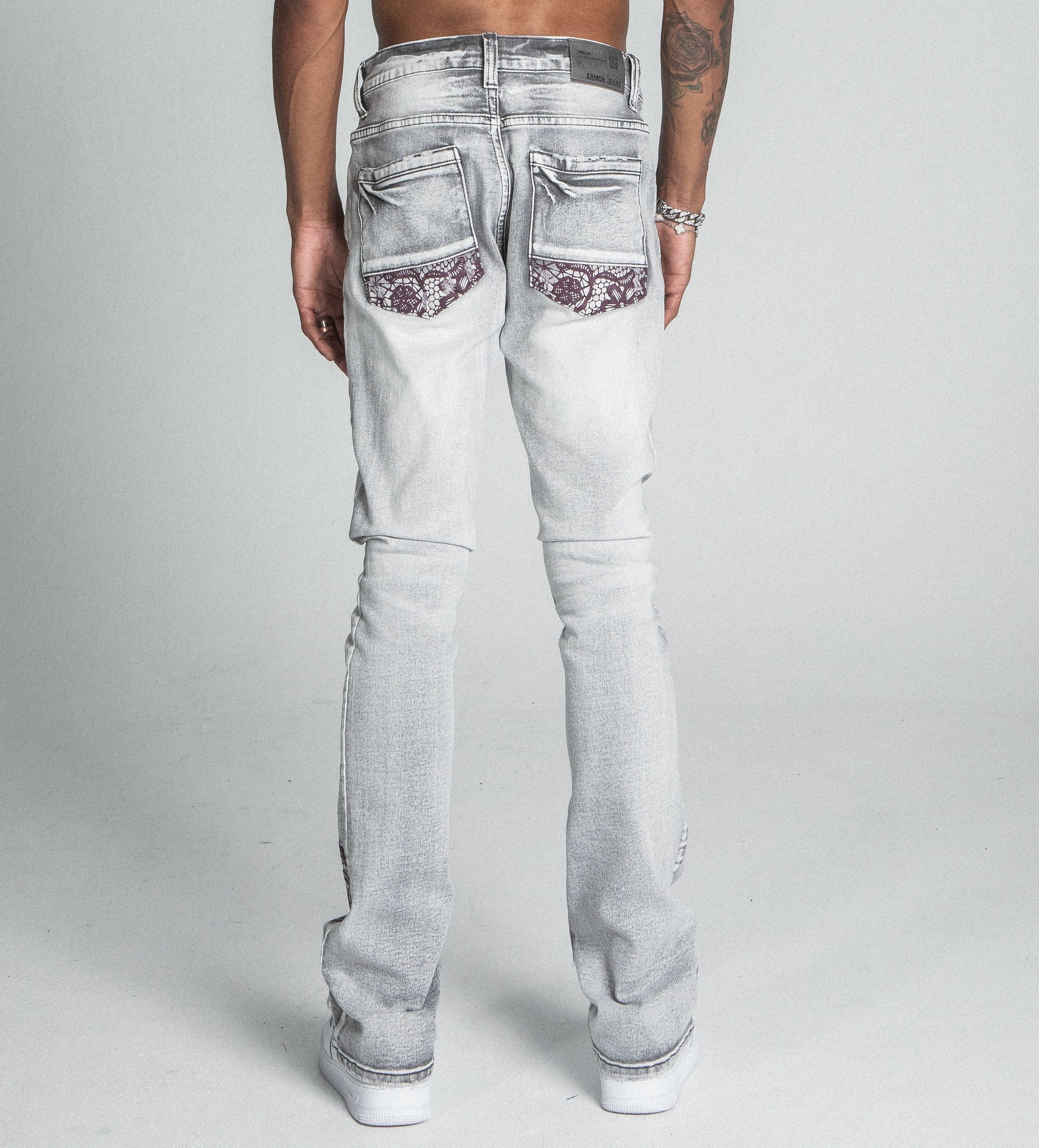 AJ27SK LACE FADED WASH STACKED JEANS with lace detailing and five-pocket design shown from the back view