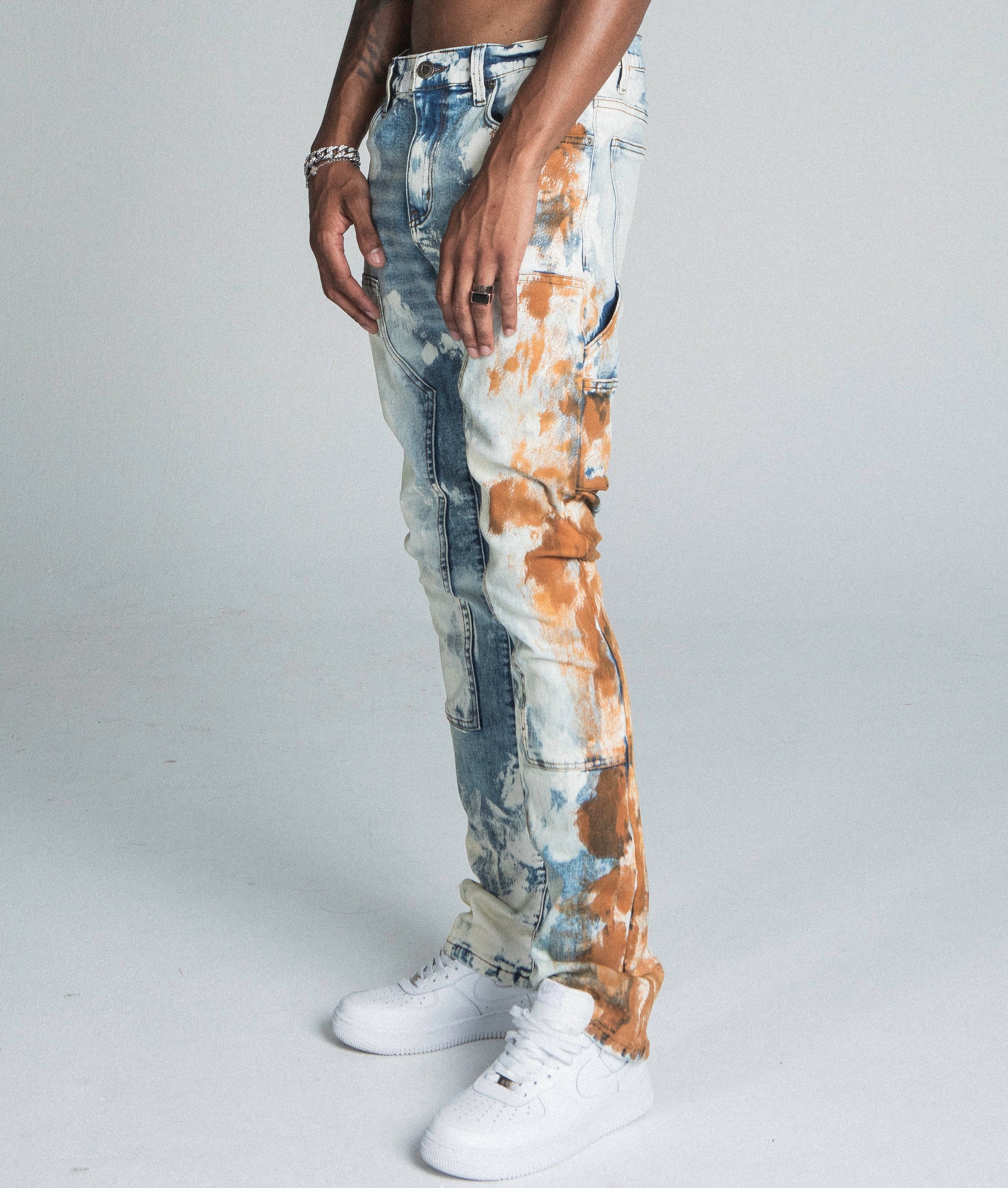 AJ19SK OIL PAINT STACKED JEANS with mid-rise waist and oil pants design, featuring a cargo pocket and stretchy cotton fabric.