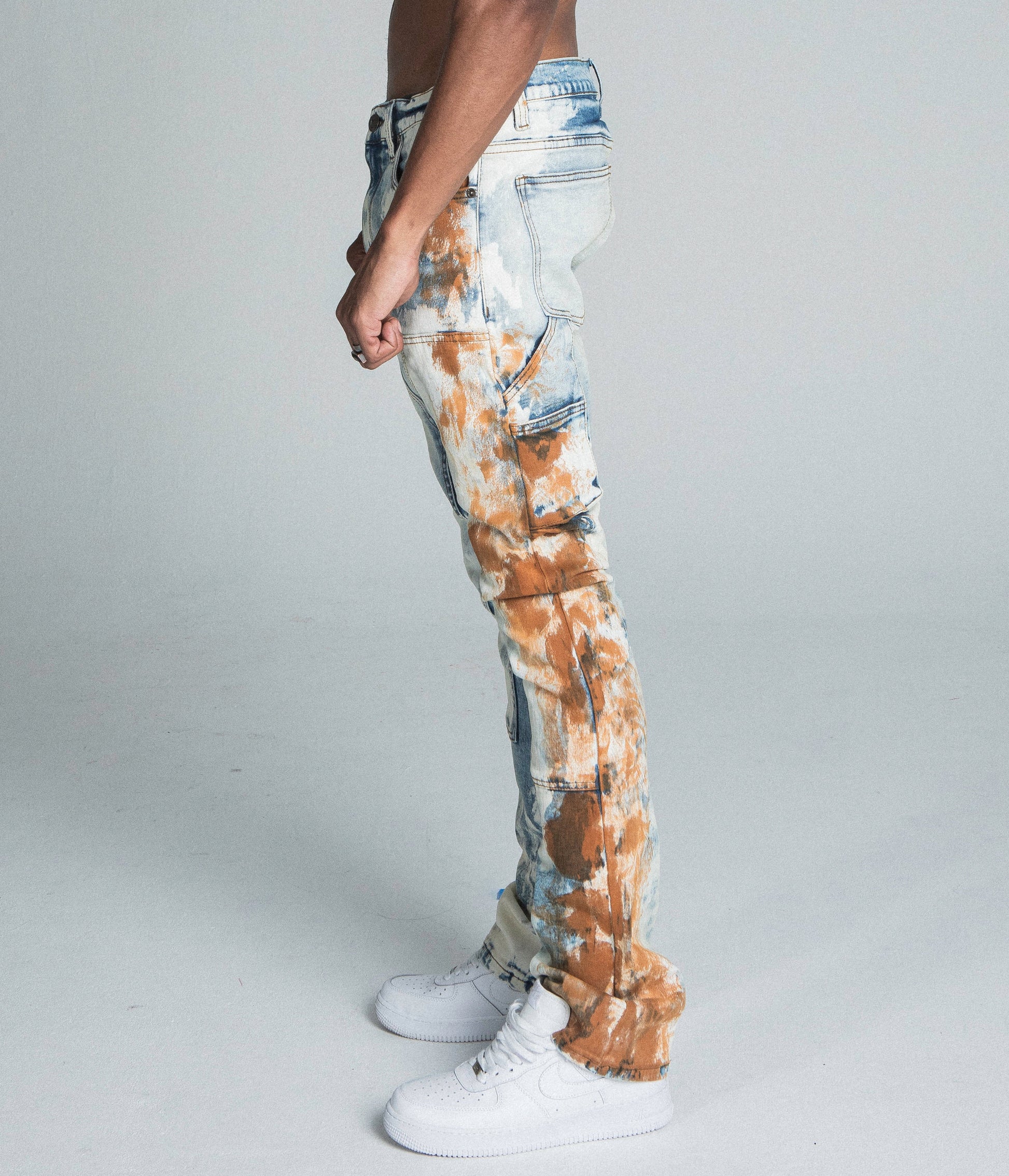 Side view of AJ19SK OIL PAINT STACKED JEANS featuring cargo pocket, mid rise, stretchy fabric, oil pants design, and traditional wash.