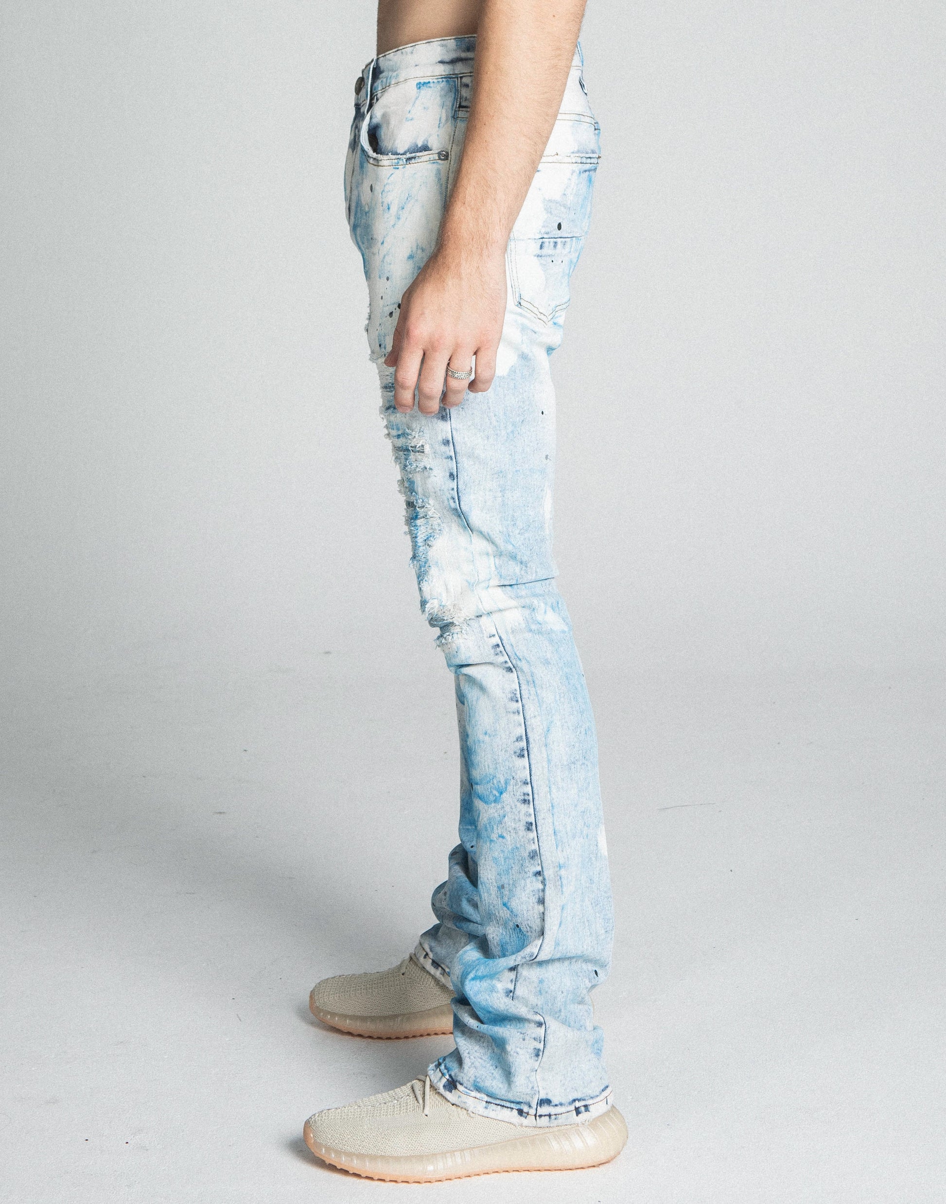 AJ28SK LIGHT BLUE/WHITE PAINT STACKED JEANS side view featuring mid-rise stretchy denim with five-pocket design and zipper fly.