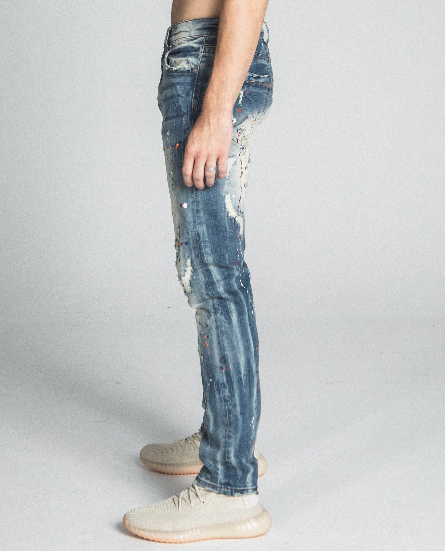 Side view of AJ738SL-1 SPLASH PAINT VINTAGE SLIM JEANS showcasing mid-rise waist, ripped design, and stretchy cotton fabric.