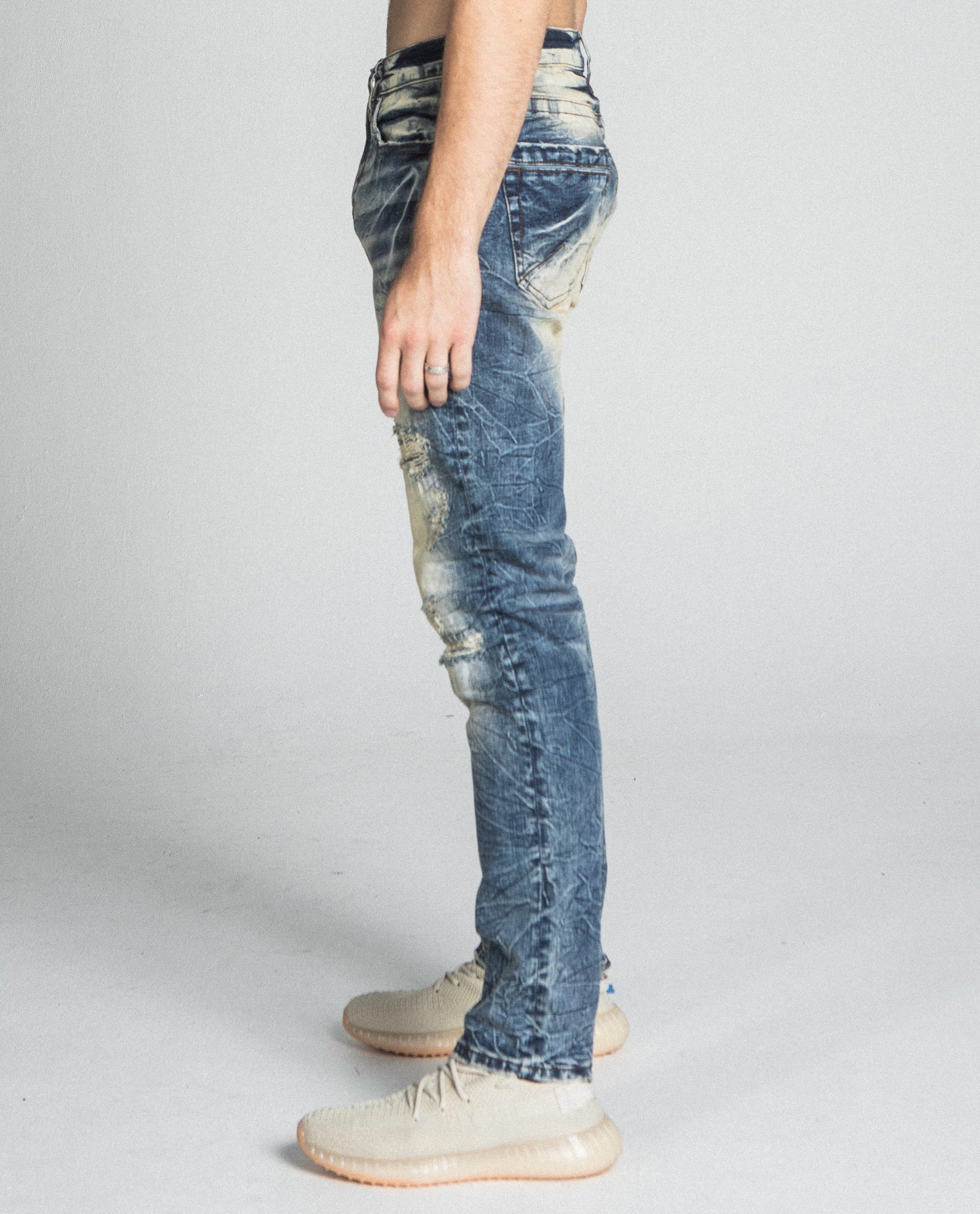 Side view of AJ722SL-1 RIPPED VINTAGE SLIM JEANS with mid rise waist and stretchy cotton fabric.