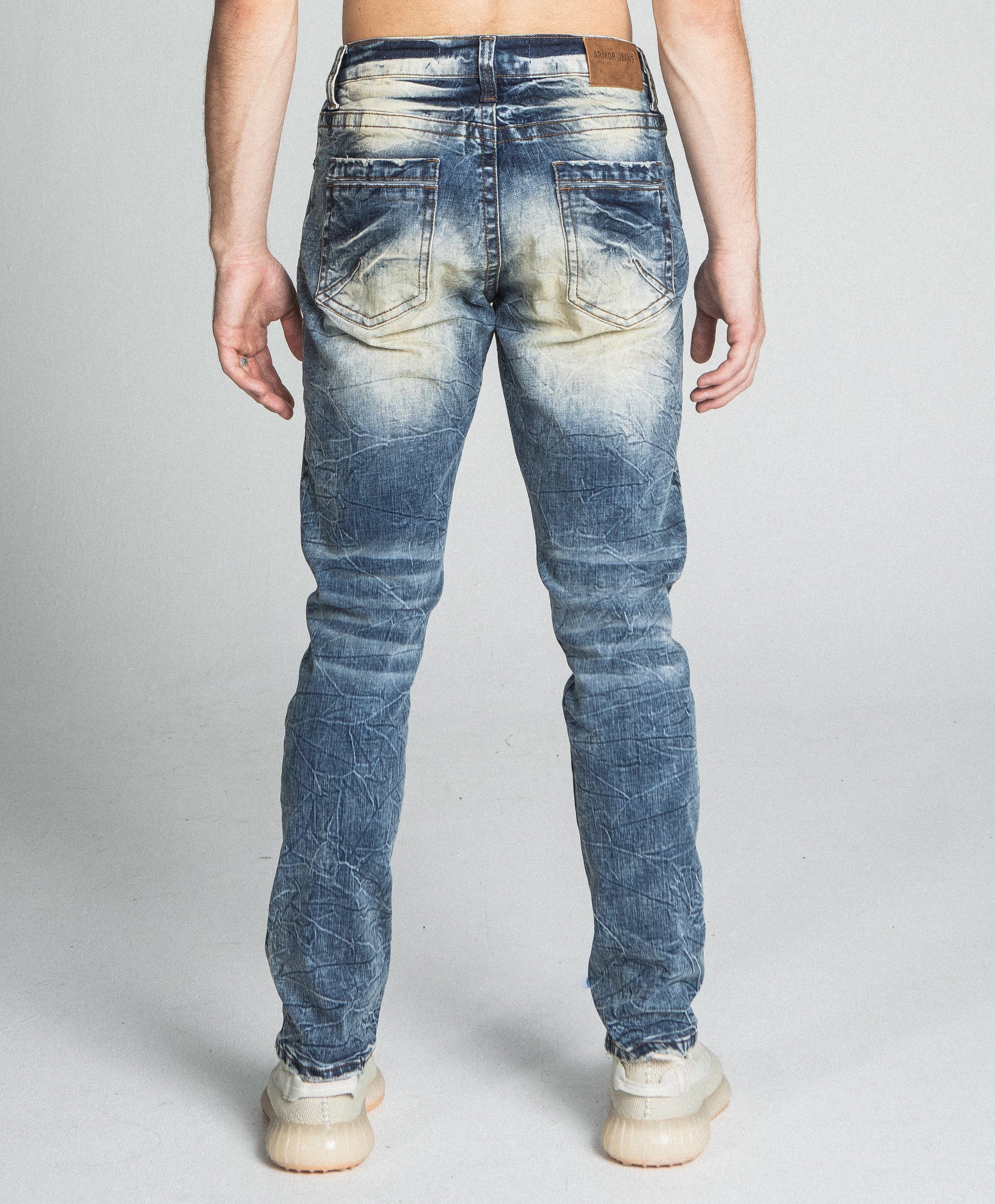 Back view of AJ722SL-1 RIPPED VINTAGE SLIM JEANS in stretchy denim with a mid-rise waist and five-pocket design on model.