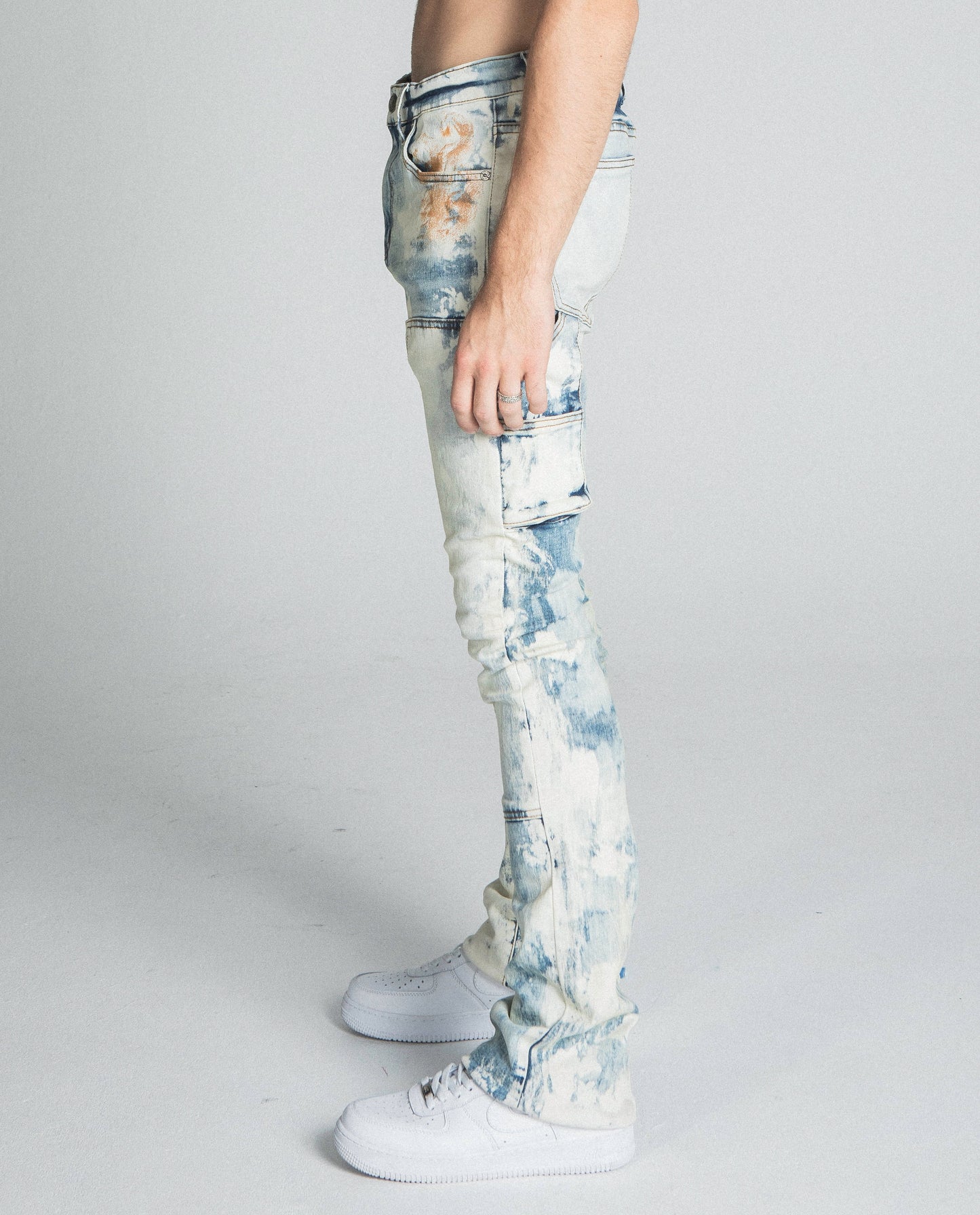 Side view of AJ19SK OIL PAINT STACKED JEANS showing mid-rise, stretchy fabric with cargo pocket and oil pants design.