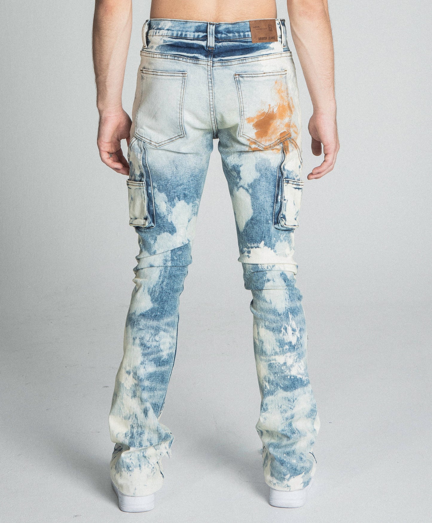 Back view of AJ19SK OIL PAINT STACKED JEANS with cargo pockets and oil paint design.
