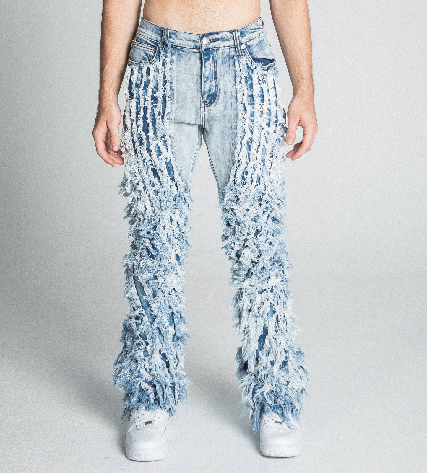 Front view of AJ18SK EXTREME FRAYED STACKED JEANS with mid-rise waist, stretchy fabric, and extreme frayed design on stacked legs.