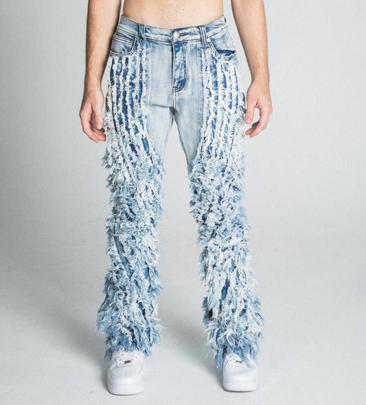 Front view of AJ18SK EXTREME FRAYED STACKED JEANS with mid-rise waist, stretchy fabric, and extreme frayed design on stacked legs.