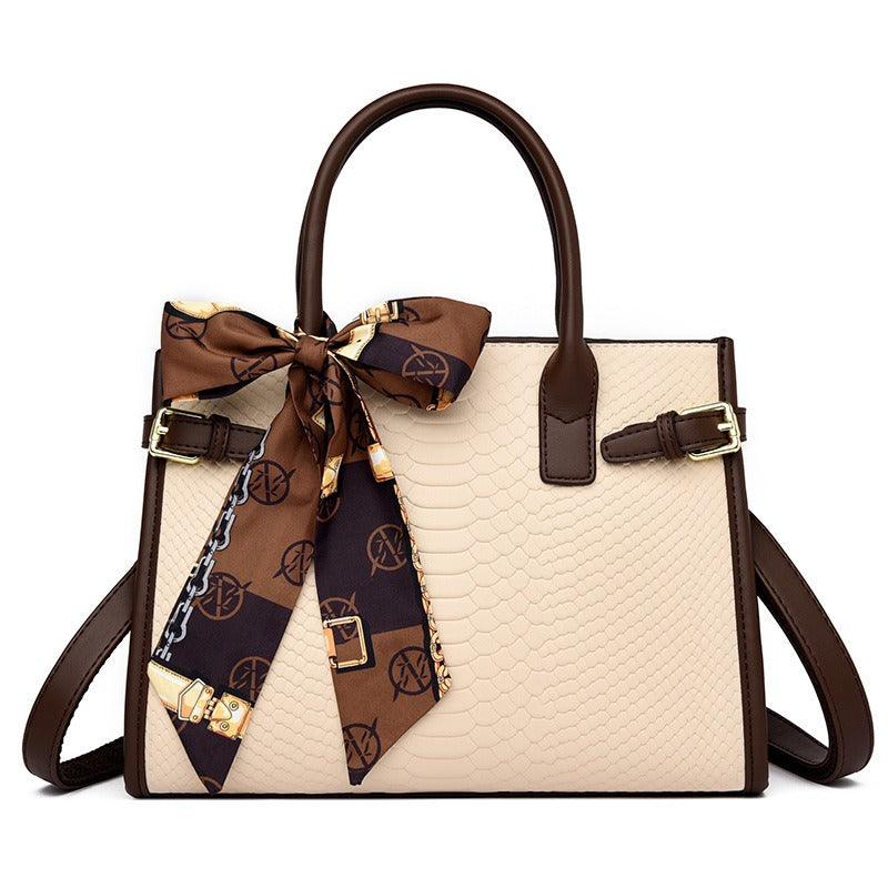 Serpent Luxe Snakeskin Handbag - Elegant Leather Commuter Bag for Stylish Women with brown accents and decorative scarf.