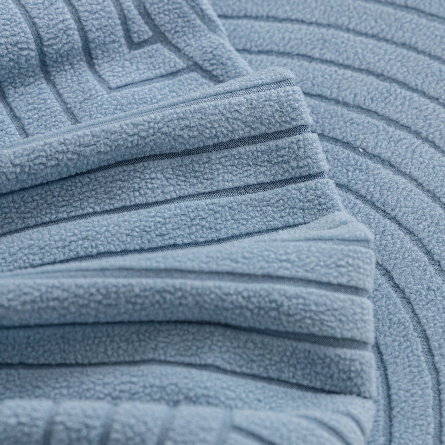 Close-up of textured Fleece Stretch Sofa Slipcover Washable Soft Spandex Couch Cover Furniture Protector in a geometric wave pattern.