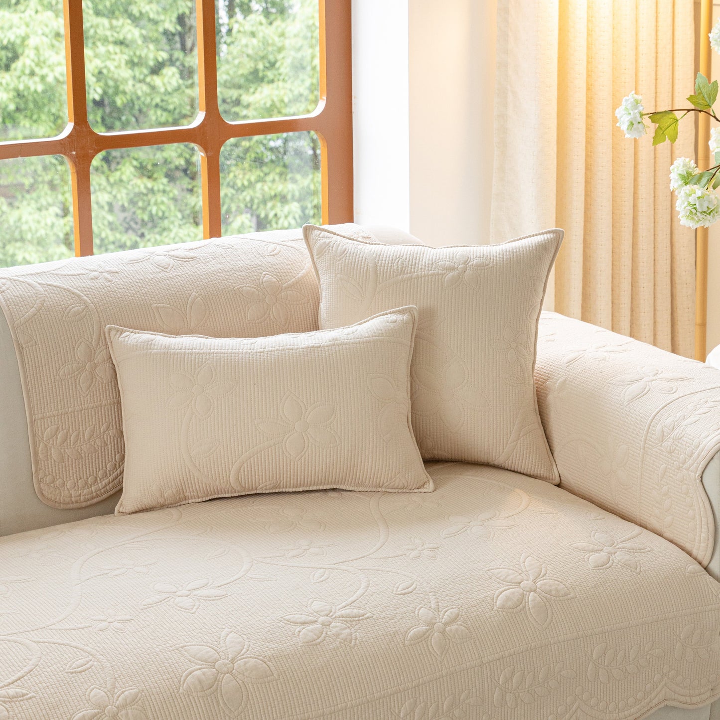 Floral Cotton Quilted Sofa Cover, Non-Slip Couch Protector with Scalloped Edges on cream couch with floral pillows