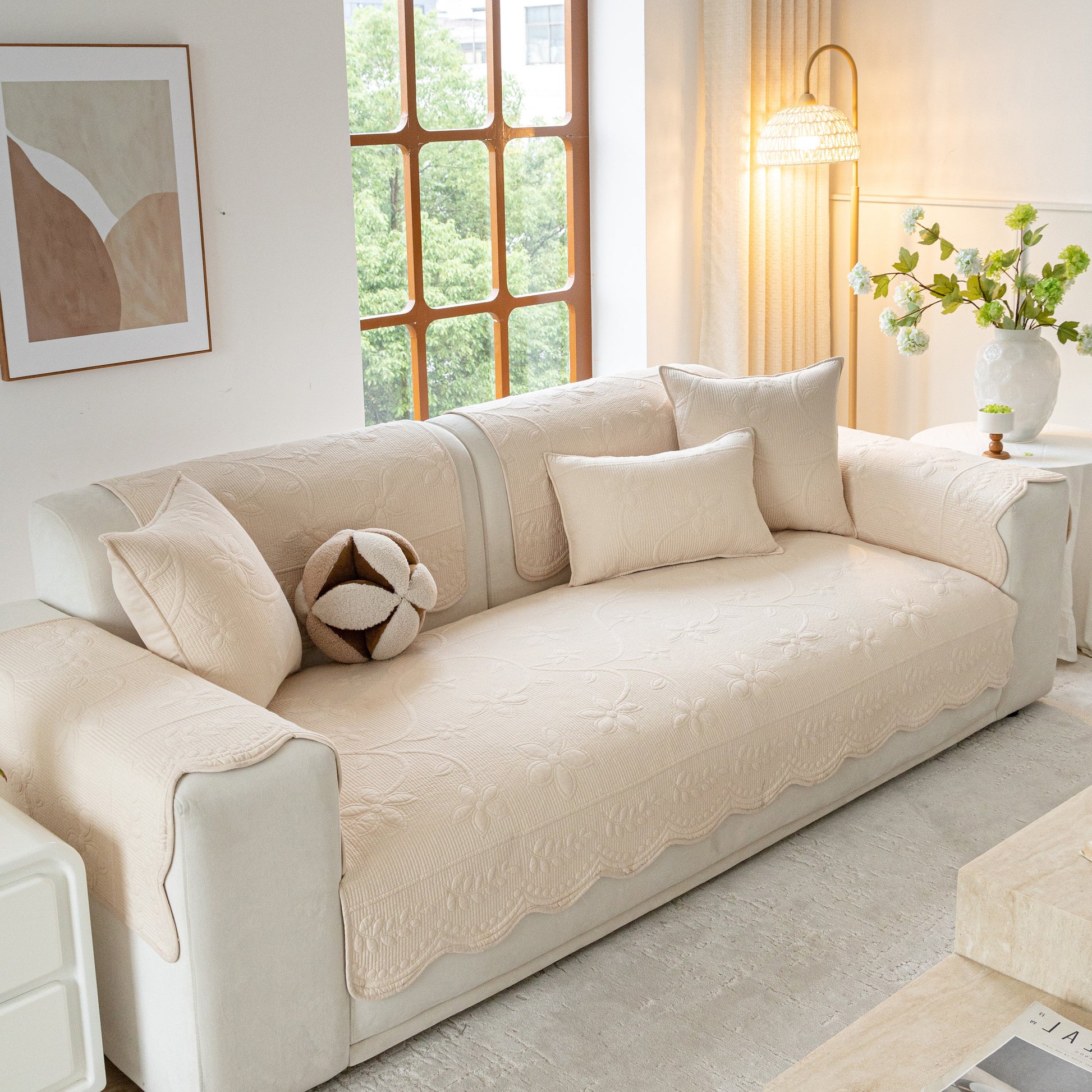 Floral Cotton Quilted Sofa Cover, Non-Slip Couch Protector with Scalloped Edges in a modern living room setting