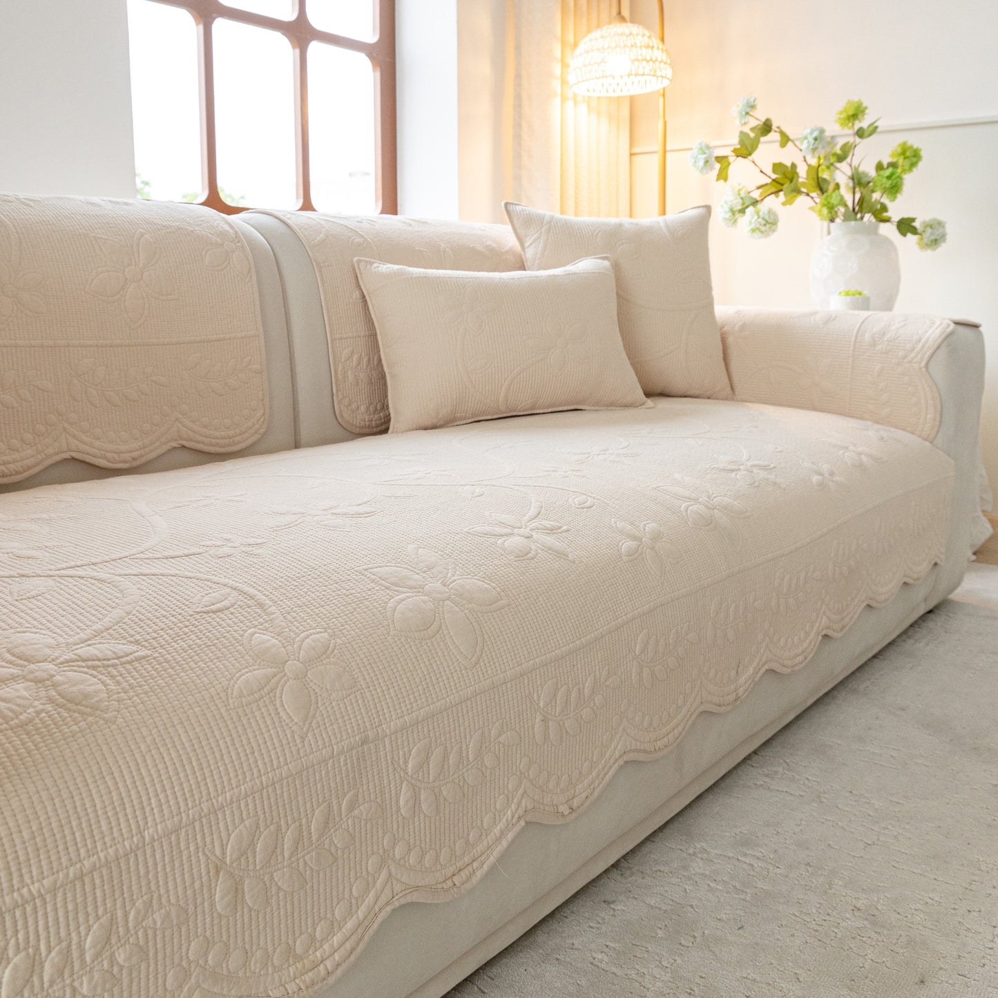 Floral Cotton Quilted Sofa Cover, Non-Slip Couch Protector with Scalloped Edges in elegant living room setting