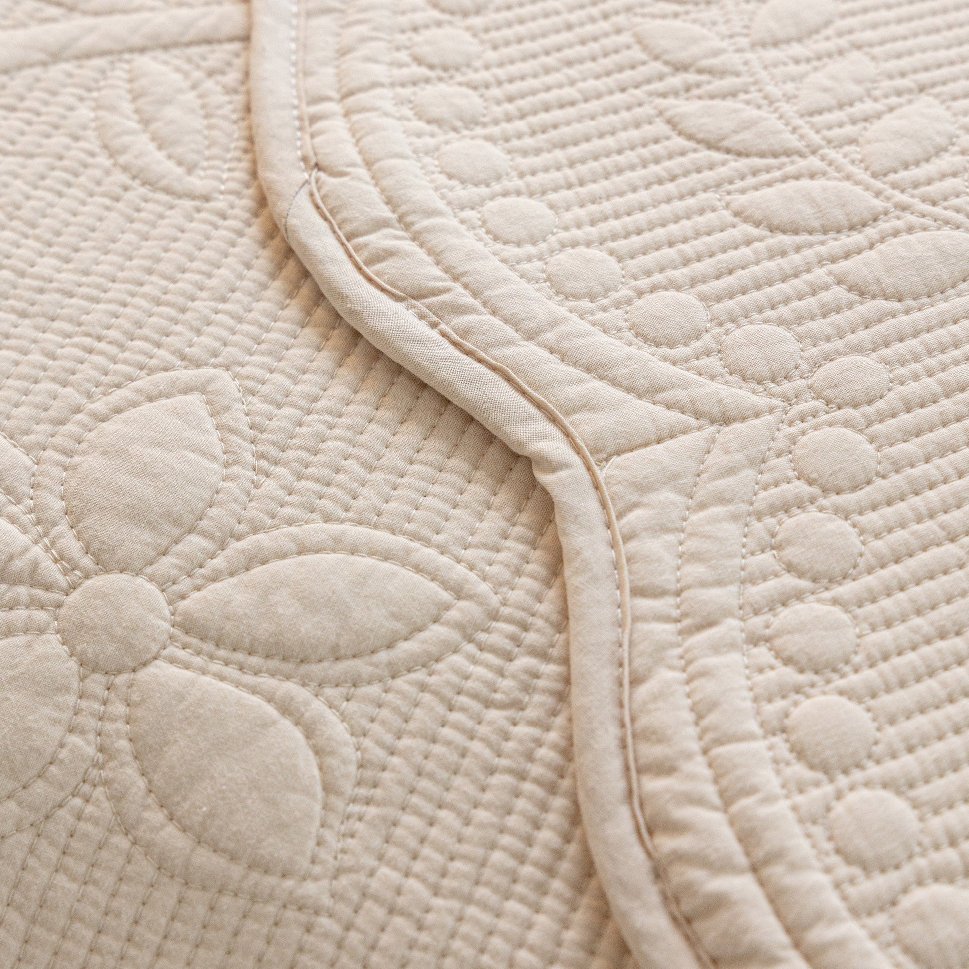 Floral Cotton Quilted Sofa Cover, Non-Slip Couch Protector with Scalloped Edges, embroidered with delicate floral patterns.