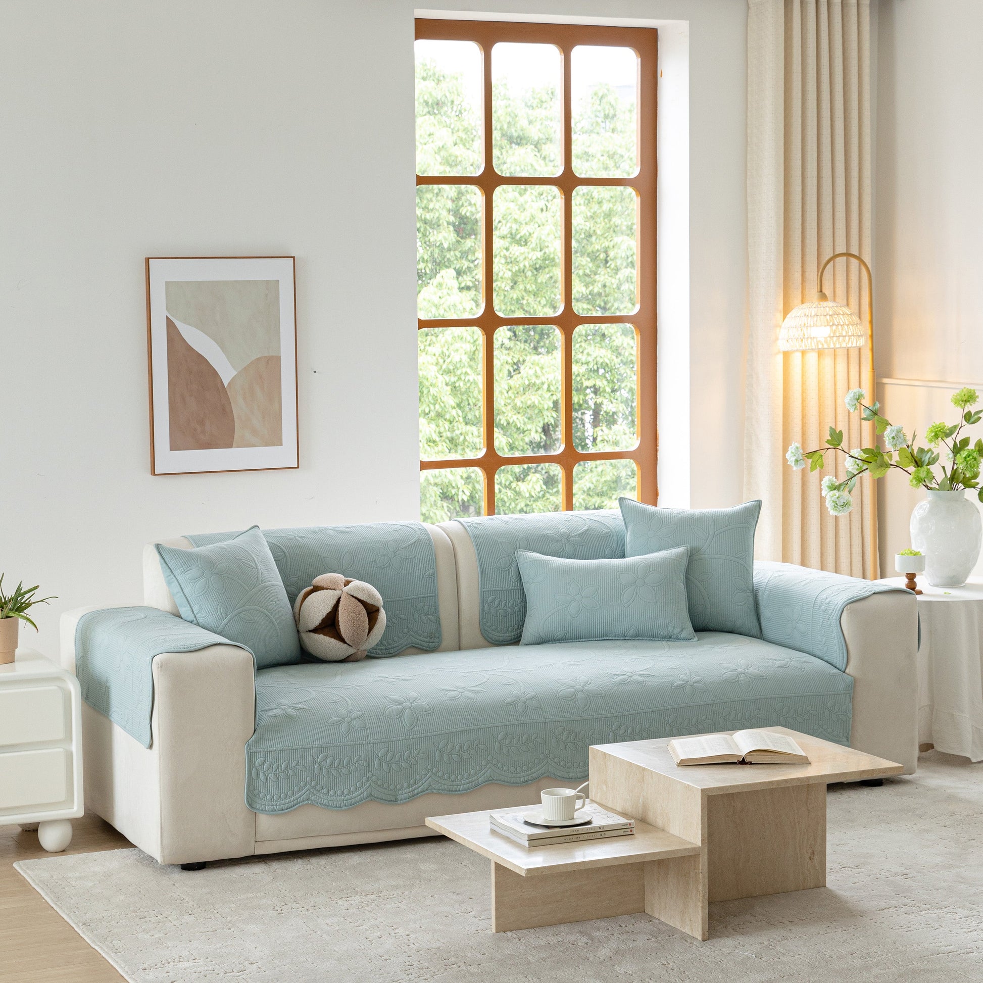 Living room with Floral Cotton Quilted Sofa Cover, Non-Slip Couch Protector with Scalloped Edges in light blue