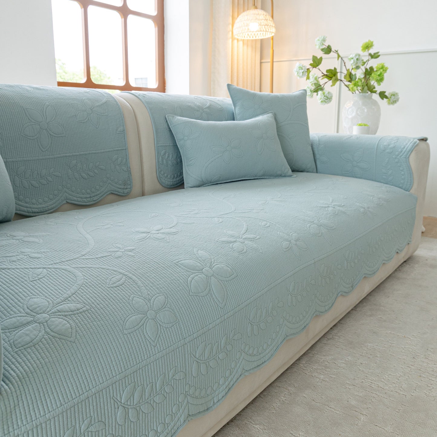 Floral Cotton Quilted Sofa Cover, Non-Slip Couch Protector with Scalloped Edges in elegant light blue design, adding comfort and style.