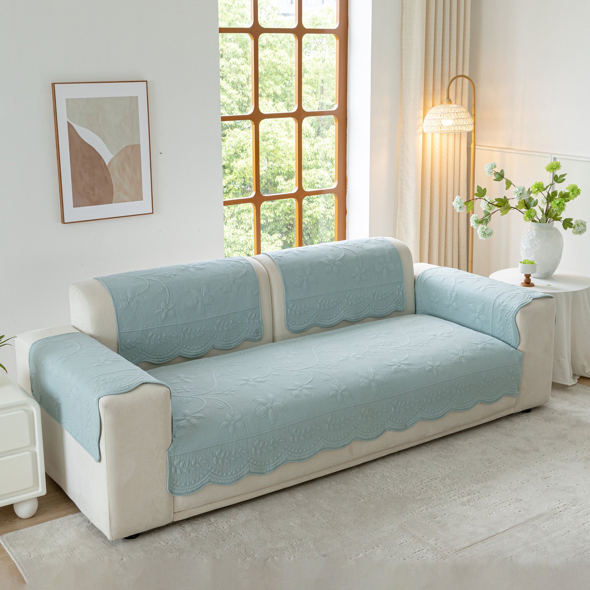 Floral Cotton Quilted Sofa Cover, Non-Slip Couch Protector with Scalloped Edges in a cozy living room setting.