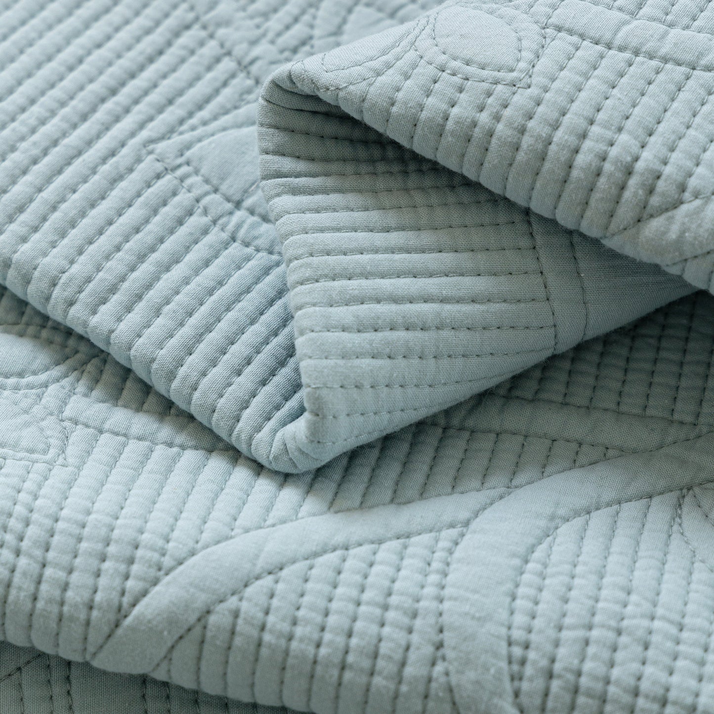 Floral Cotton Quilted Sofa Cover, Non-Slip Couch Protector with Scalloped Edges featuring delicate quilting texture.