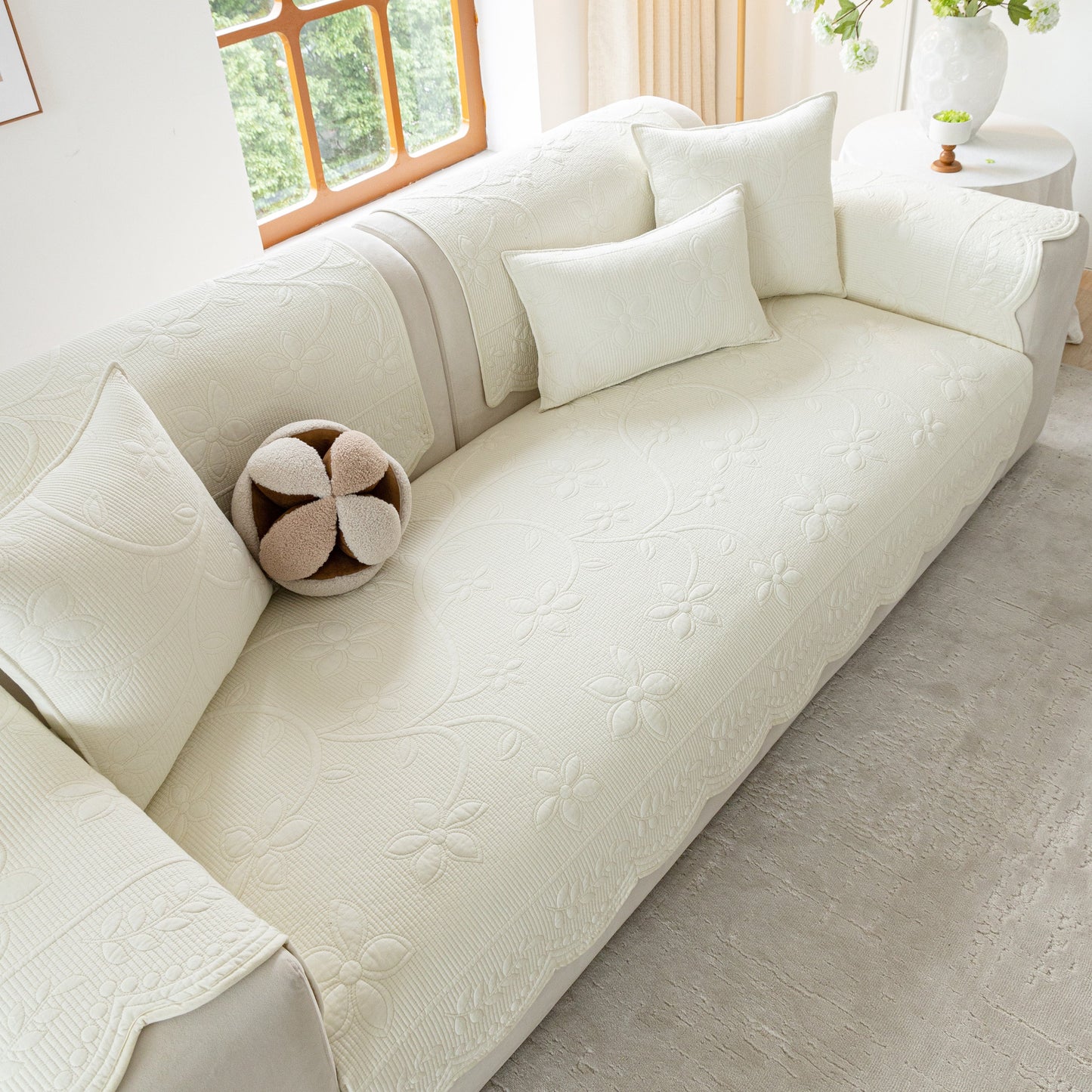 Floral Cotton Quilted Sofa Cover, Non-Slip Couch Protector with Scalloped Edges on white couch