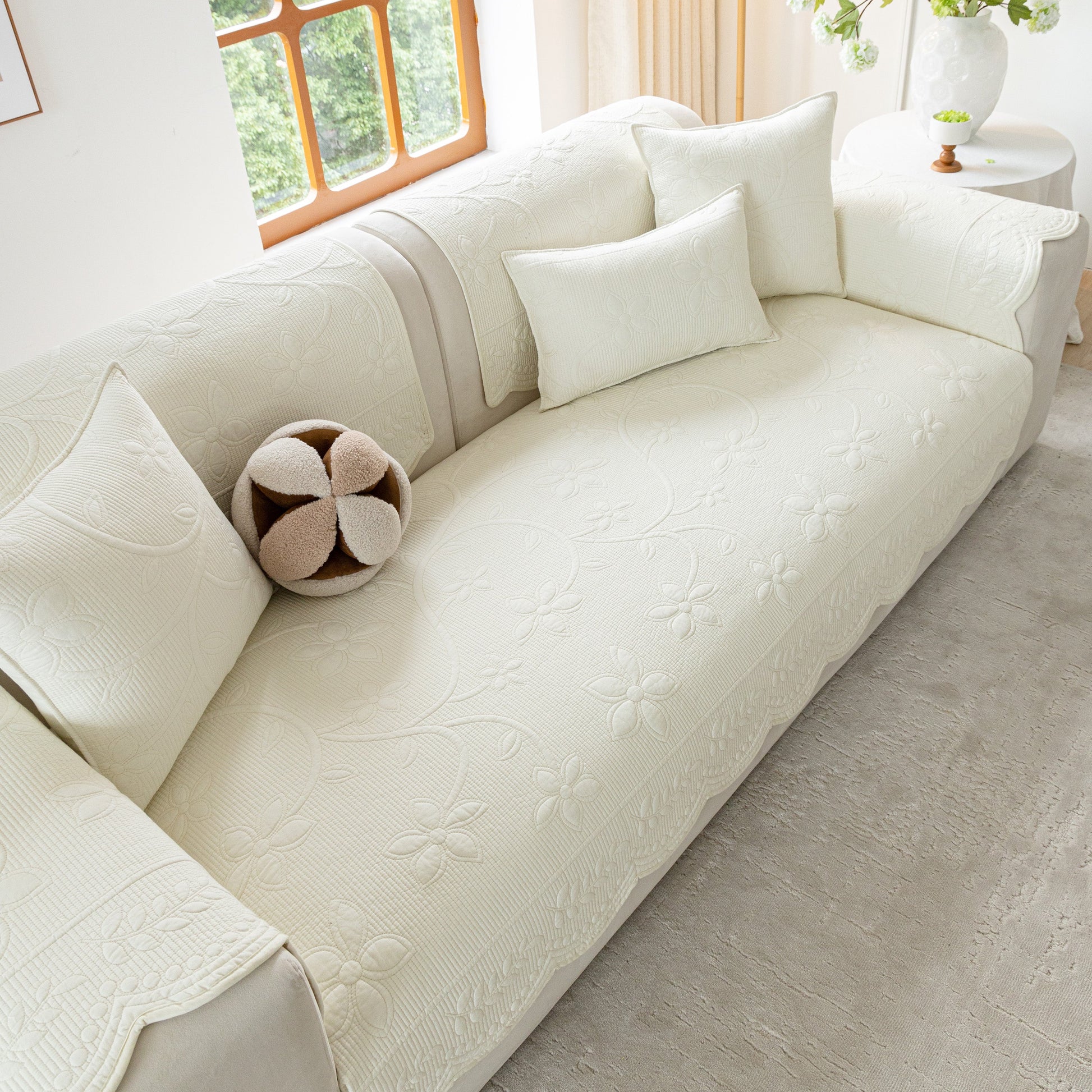 Floral Cotton Quilted Sofa Cover, Non-Slip Couch Protector with Scalloped Edges on white couch