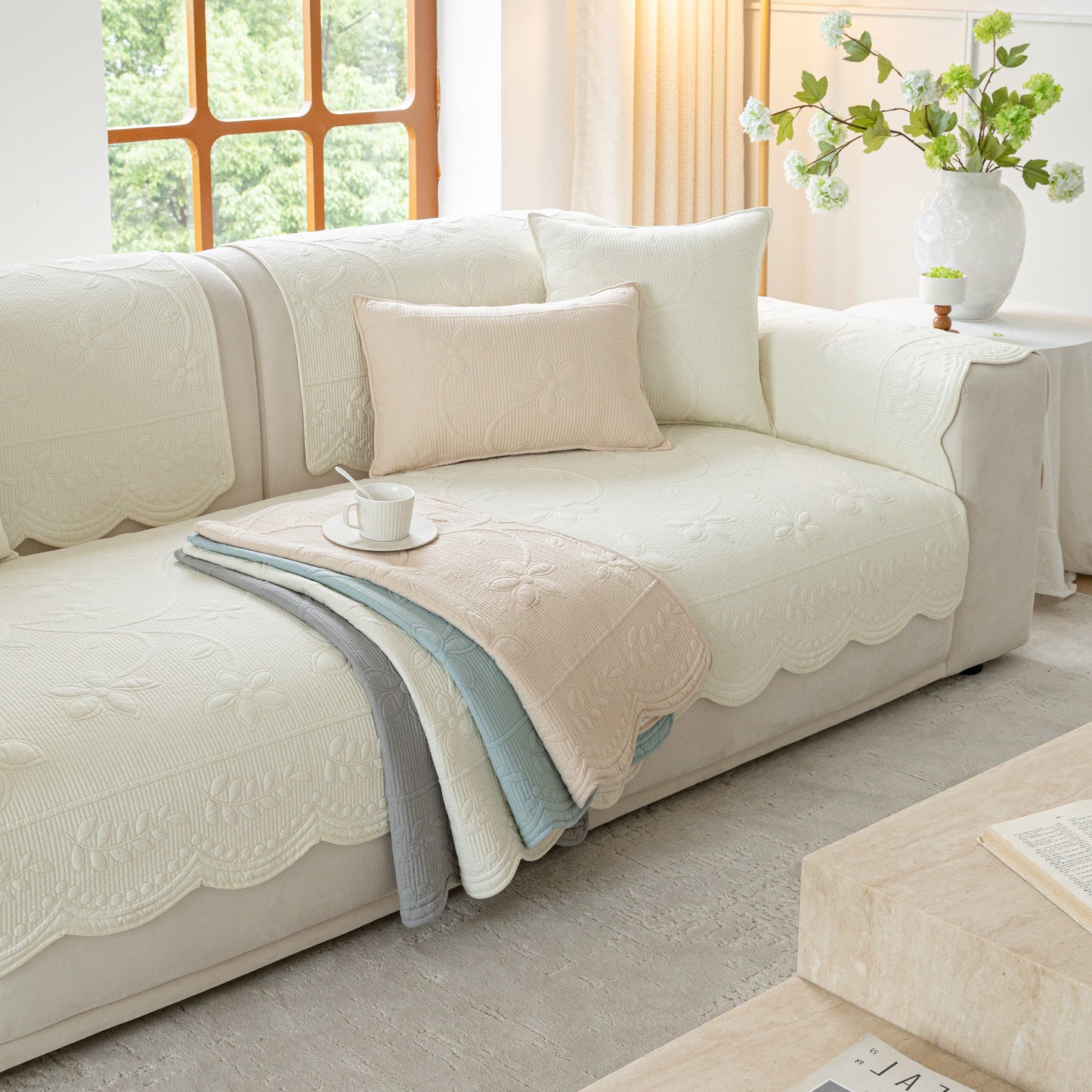 Floral Cotton Quilted Sofa Cover, Non-Slip Couch Protector with Scalloped Edges on living room couch.