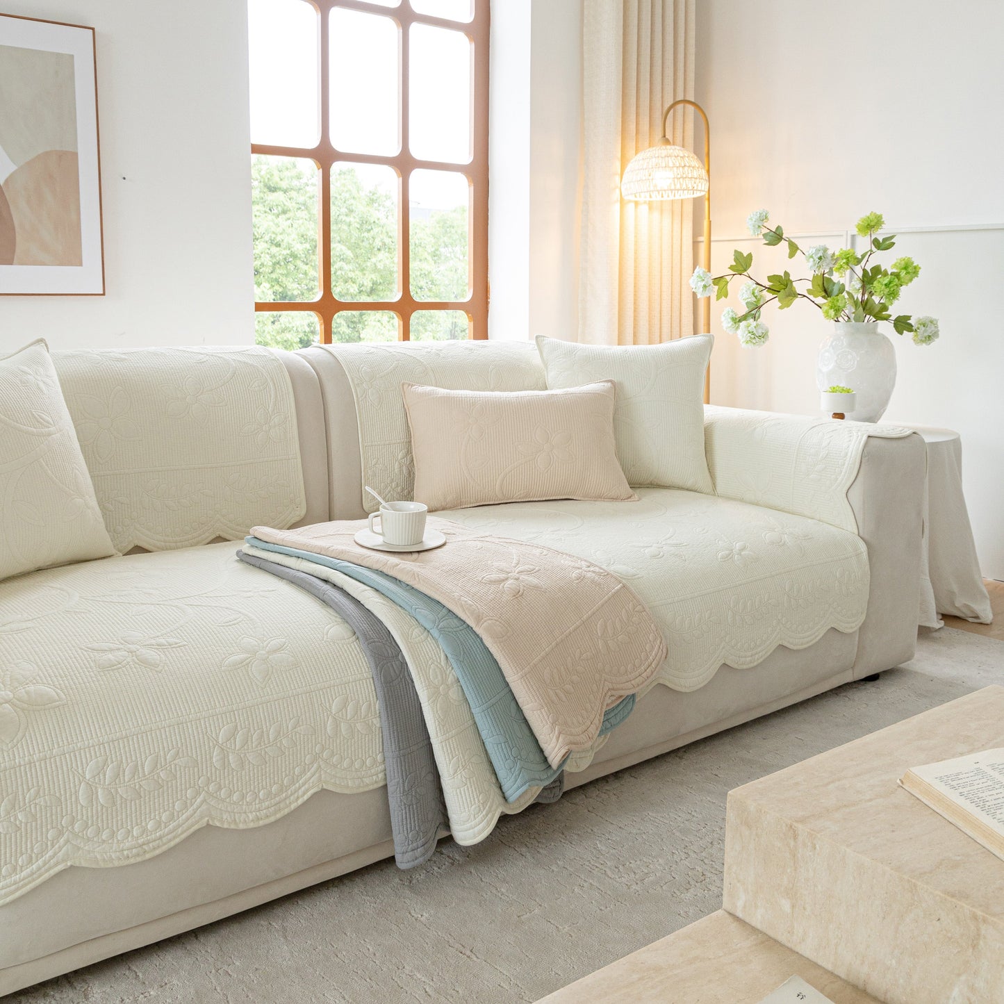 Floral Cotton Quilted Sofa Cover, Non-Slip Couch Protector with Scalloped Edges in a cozy living room setting.
