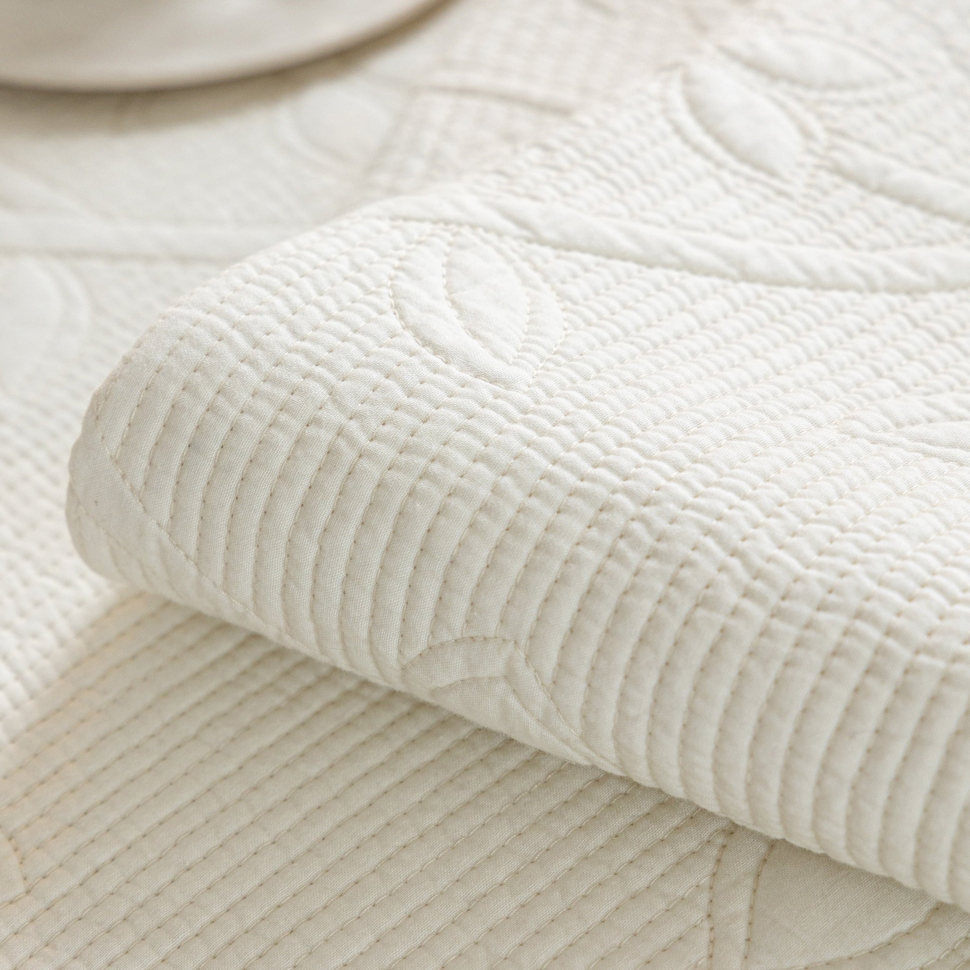 Floral Cotton Quilted Sofa Cover, Non-Slip Couch Protector with Scalloped Edges showcasing detailed embroidery.