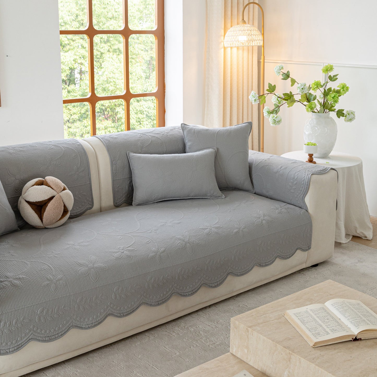 Floral Cotton Quilted Sofa Cover, Non-Slip Couch Protector with Scalloped Edges in a modern living room setting.