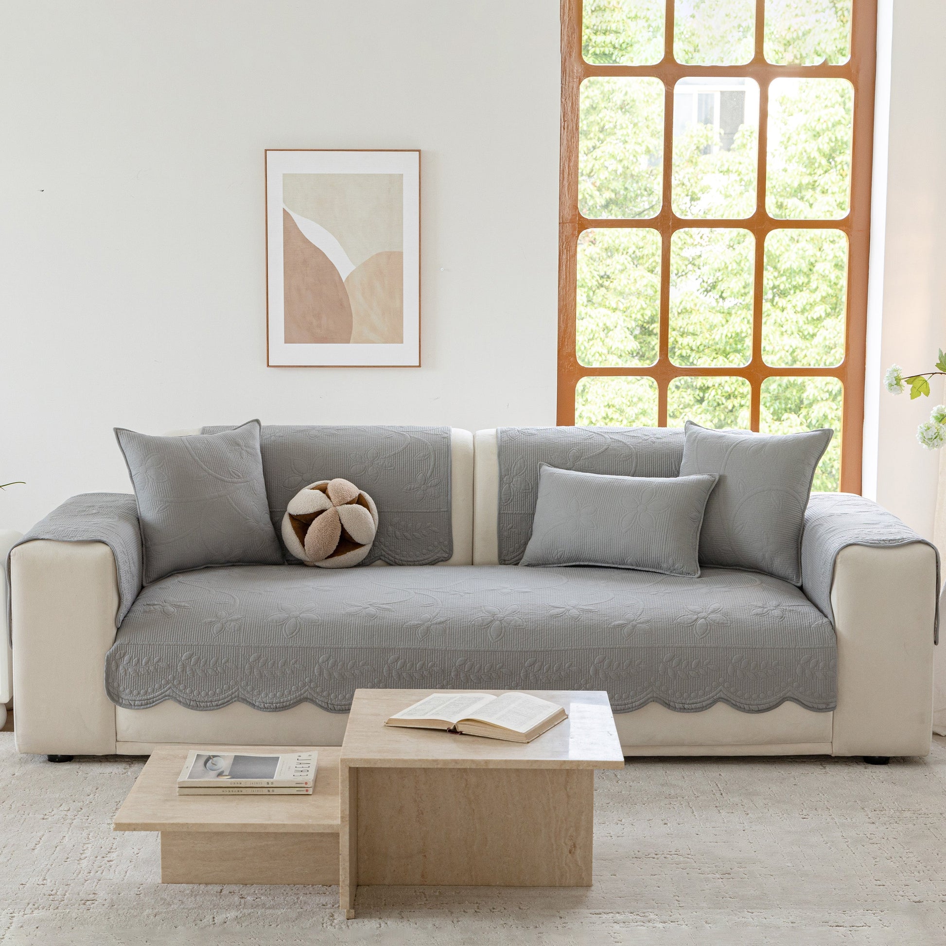 Floral Cotton Quilted Sofa Cover, Non-Slip Couch Protector with Scalloped Edges in a modern living room.