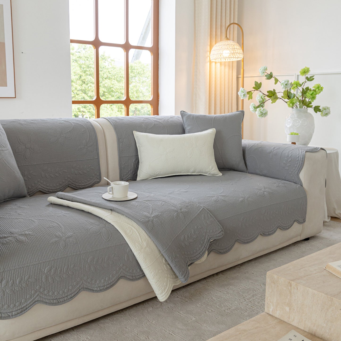 Floral Cotton Quilted Sofa Cover, Non-Slip Couch Protector with Scalloped Edges in elegant living room setting with soft natural cotton.