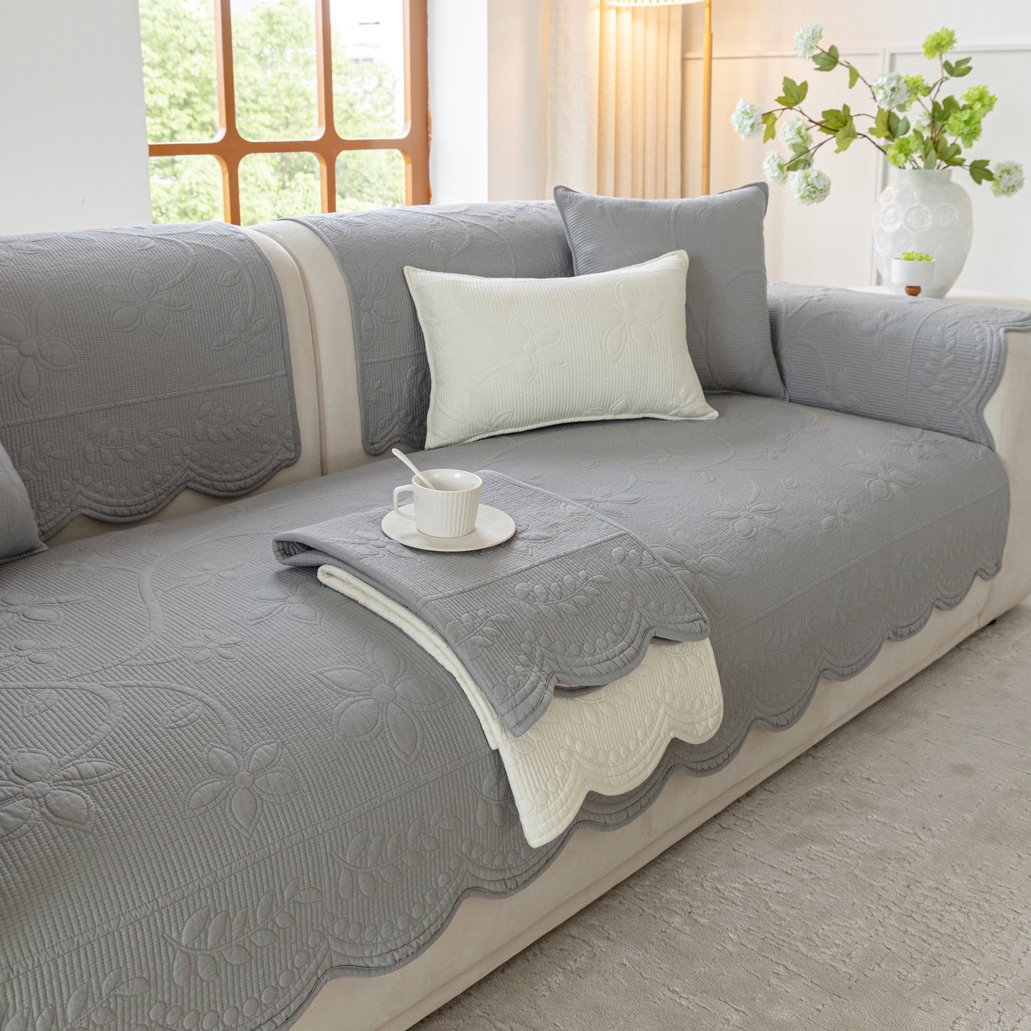 Floral Cotton Quilted Sofa Cover, Non-Slip Couch Protector with Scalloped Edges in living room setting