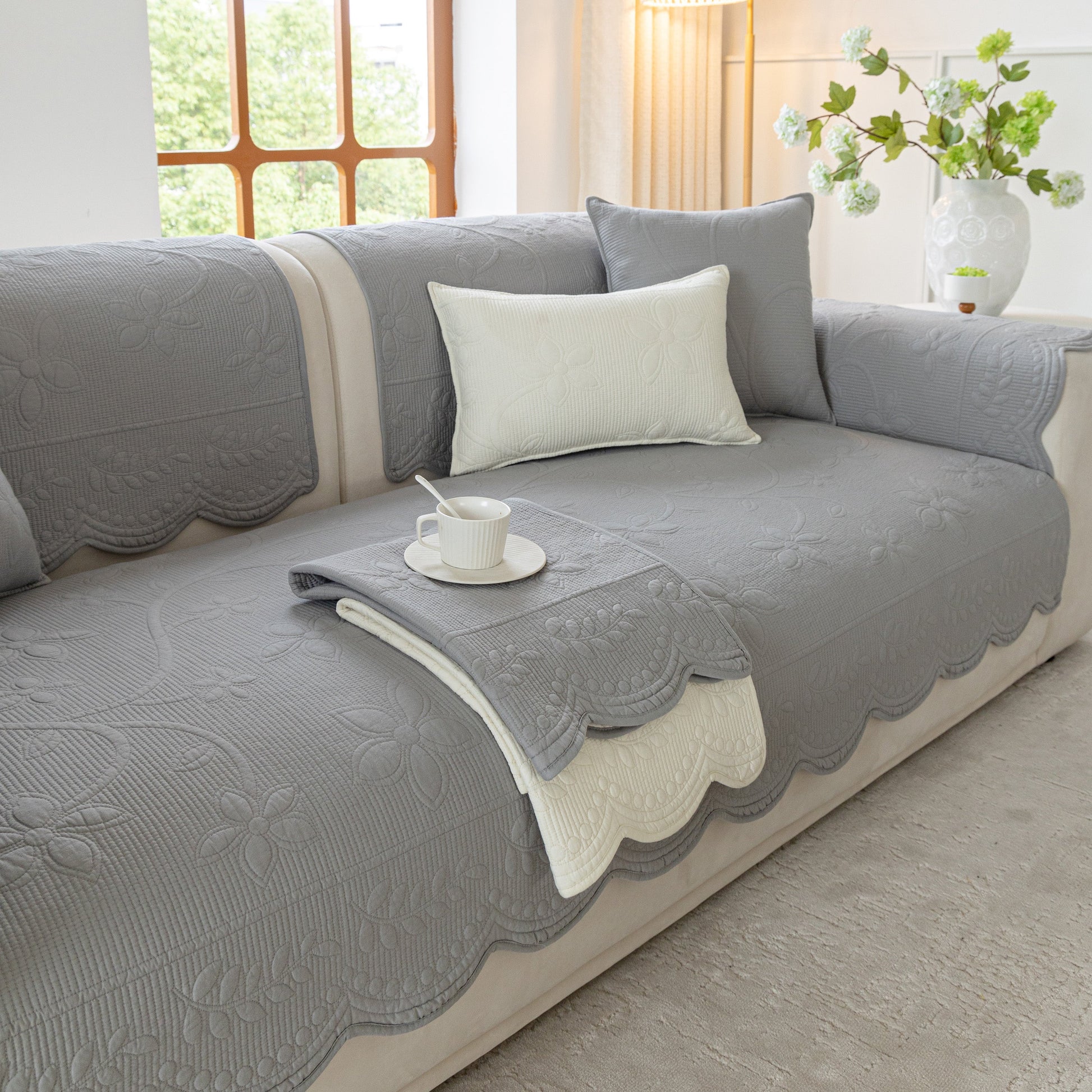 Floral Cotton Quilted Sofa Cover, Non-Slip Couch Protector with Scalloped Edges in living room setting