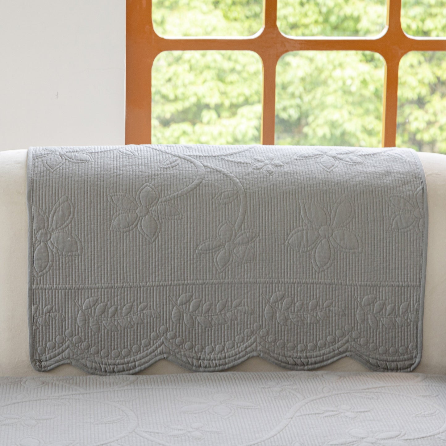 Floral Cotton Quilted Sofa Cover, Non-Slip Couch Protector with Scalloped Edges showcasing delicate embroidery and scalloped design.