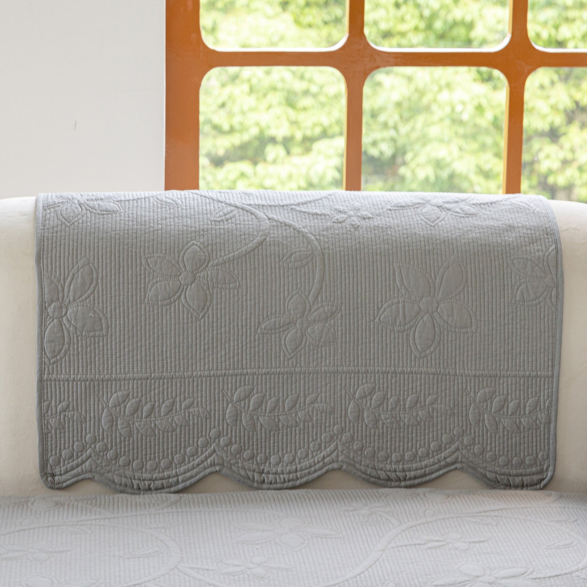 Floral Cotton Quilted Sofa Cover, Non-Slip Couch Protector with Scalloped Edges showcasing delicate embroidery and scalloped design.