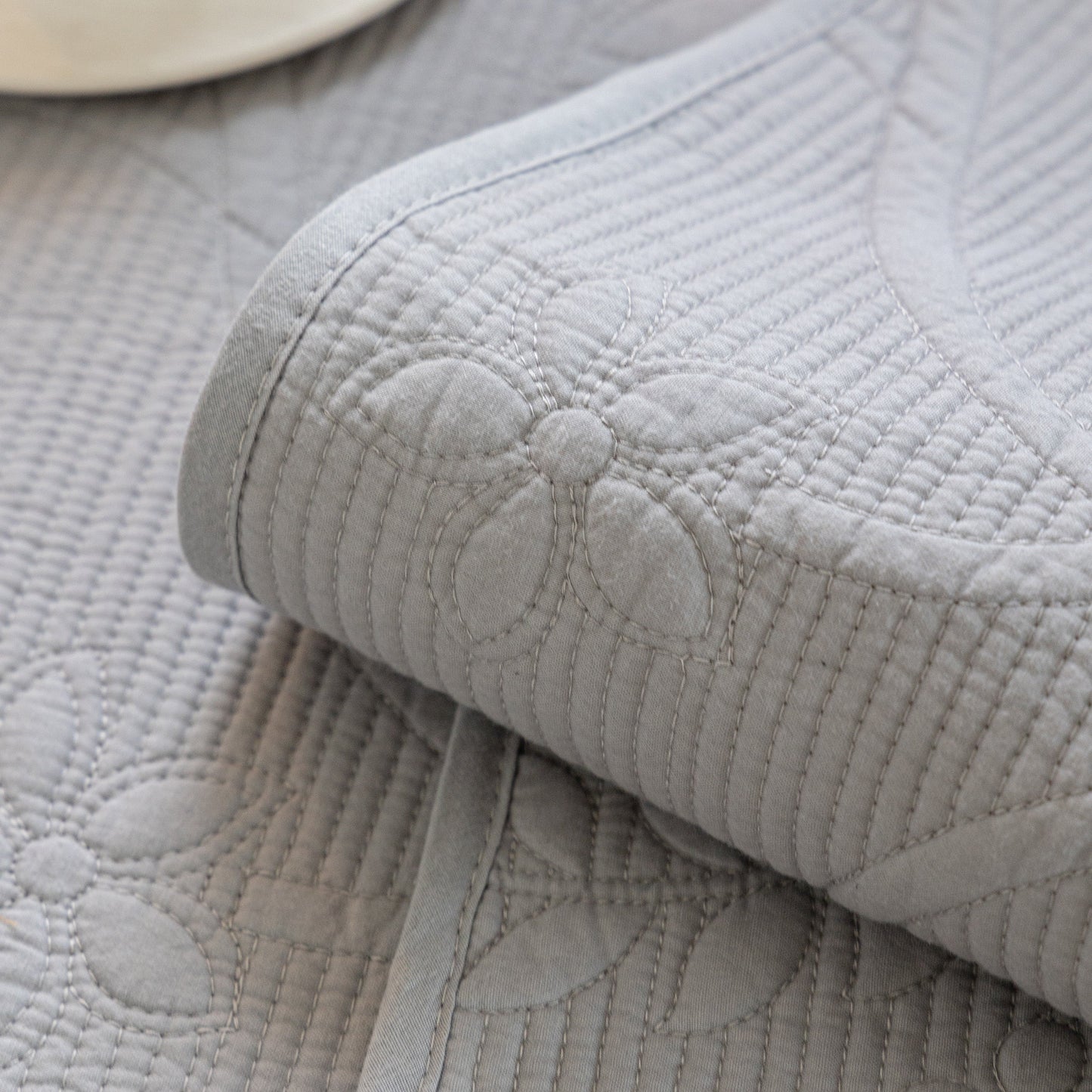 Floral Cotton Quilted Sofa Cover, Non-Slip Couch Protector with Scalloped Edges in grey with floral embroidery detail