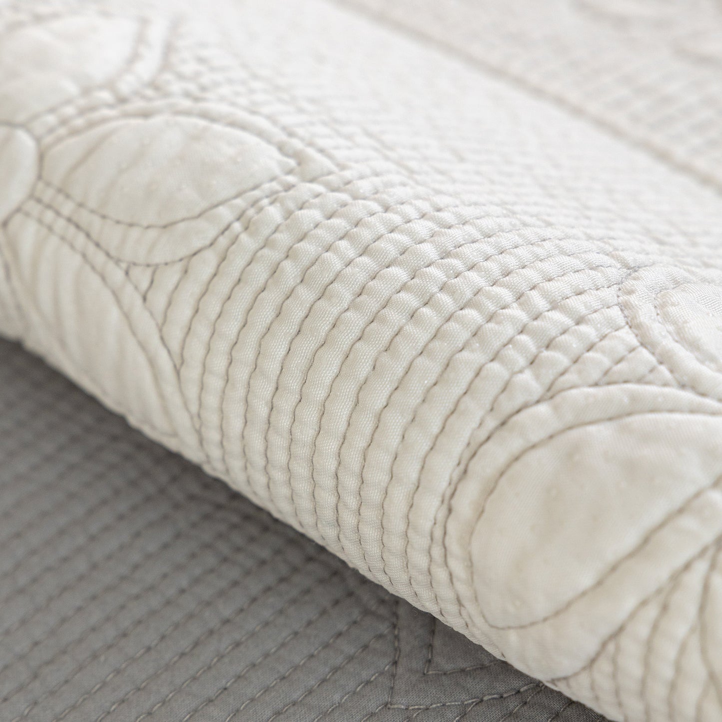 Close-up of Floral Cotton Quilted Sofa Cover, Non-Slip Couch Protector with Scalloped Edges showcasing floral embroidery detail.