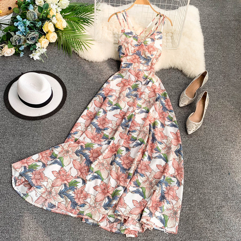 Floral summer dress with colorful flowers, displayed with shoes and a hat.