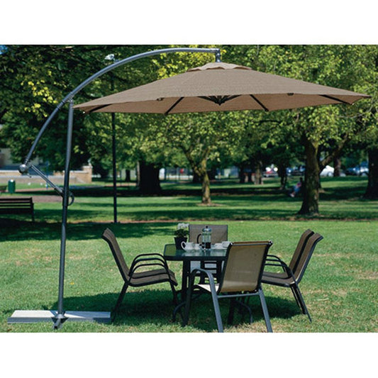 10 Foot Mocha Offset Patio Canopy Umbrella Rotates 360 Degrees providing shade over outdoor dining set in a park.