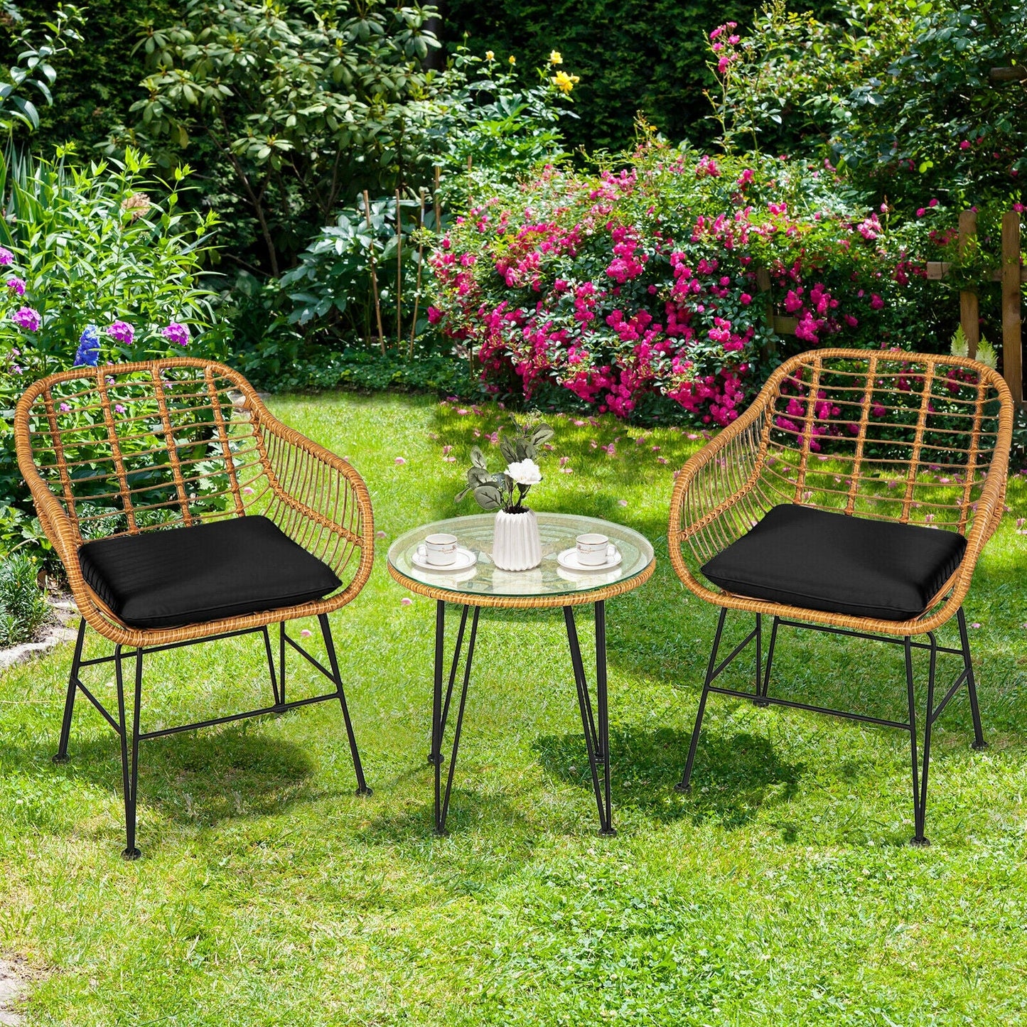 3 Pieces Rattan Furniture Set with Cushioned Chair Table-Black in garden setting, includes tempered glass table and two wicker chairs.