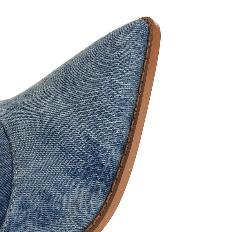 Close-up of Tie Dye Denim Knee-High Cowgirl Boots with pointed toe and brown sole