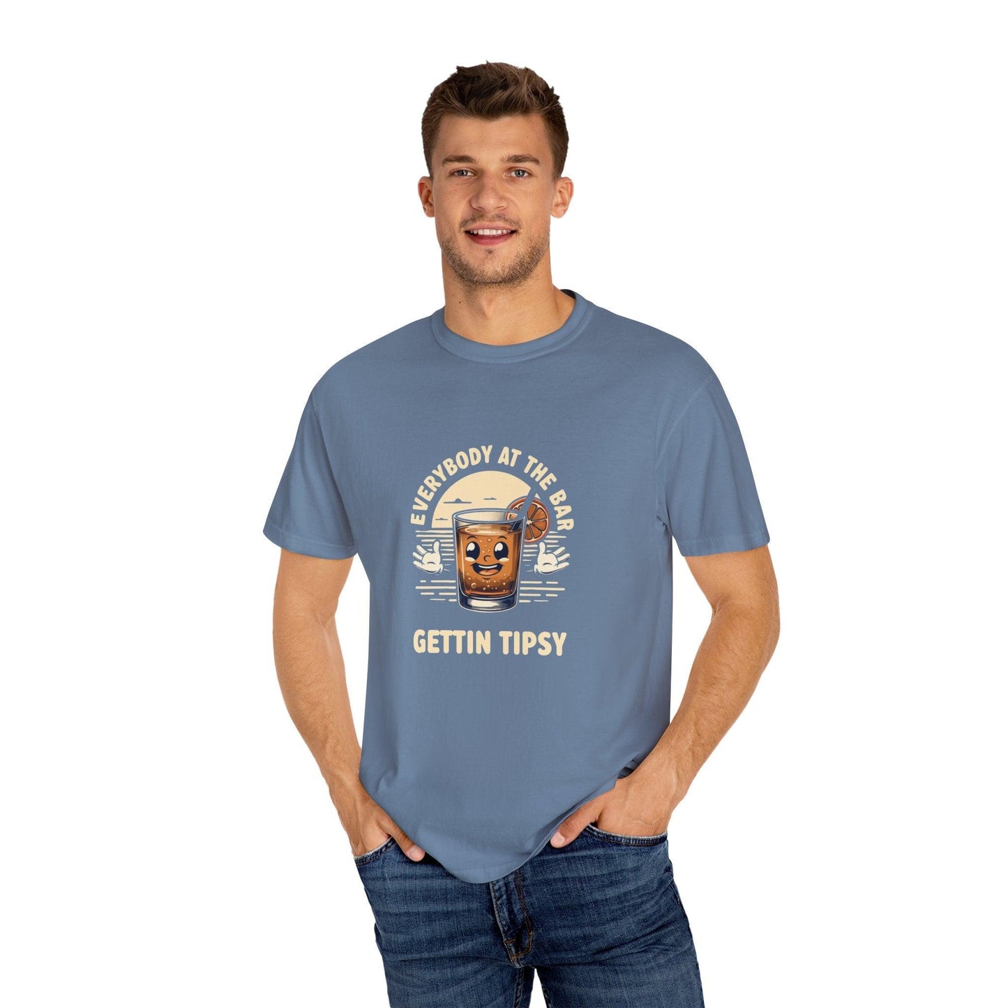 Man wearing Everybody at the Bar Gettin Tipsy Unisex Garment-Dyed T-Shirt with whiskey glass graphic and text.