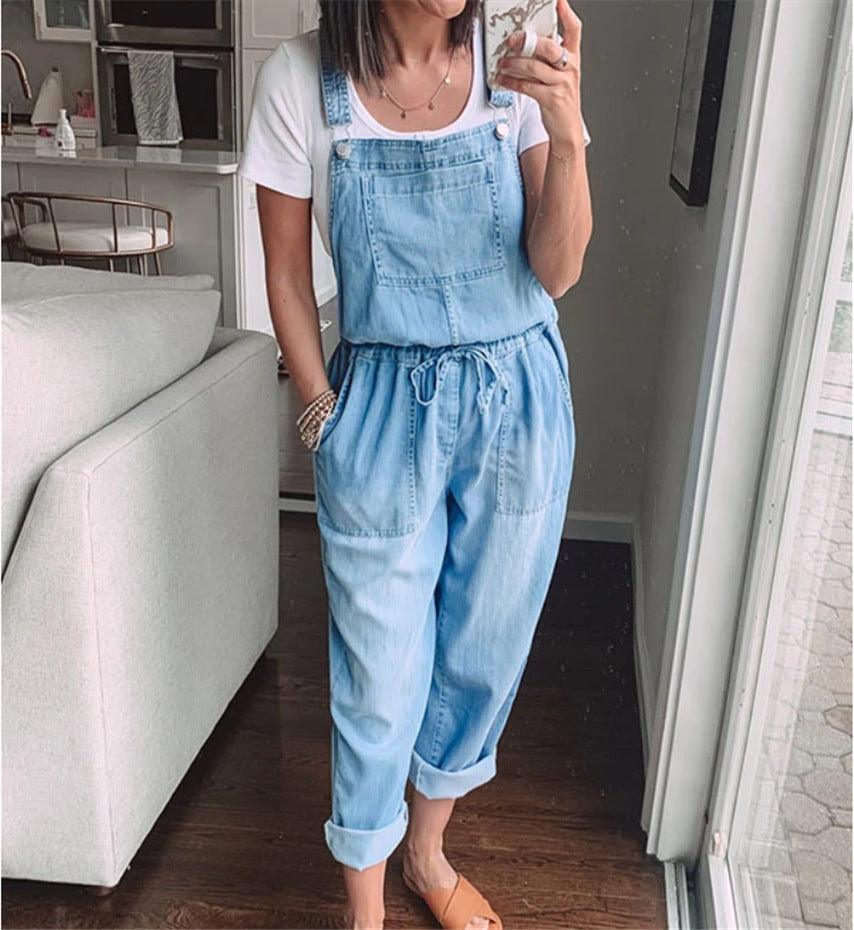 Woman wearing Cowgirl Drawstring Denim Overalls, comfortable & stylish for every cowgirl, styled with a white t-shirt, standing indoors.
