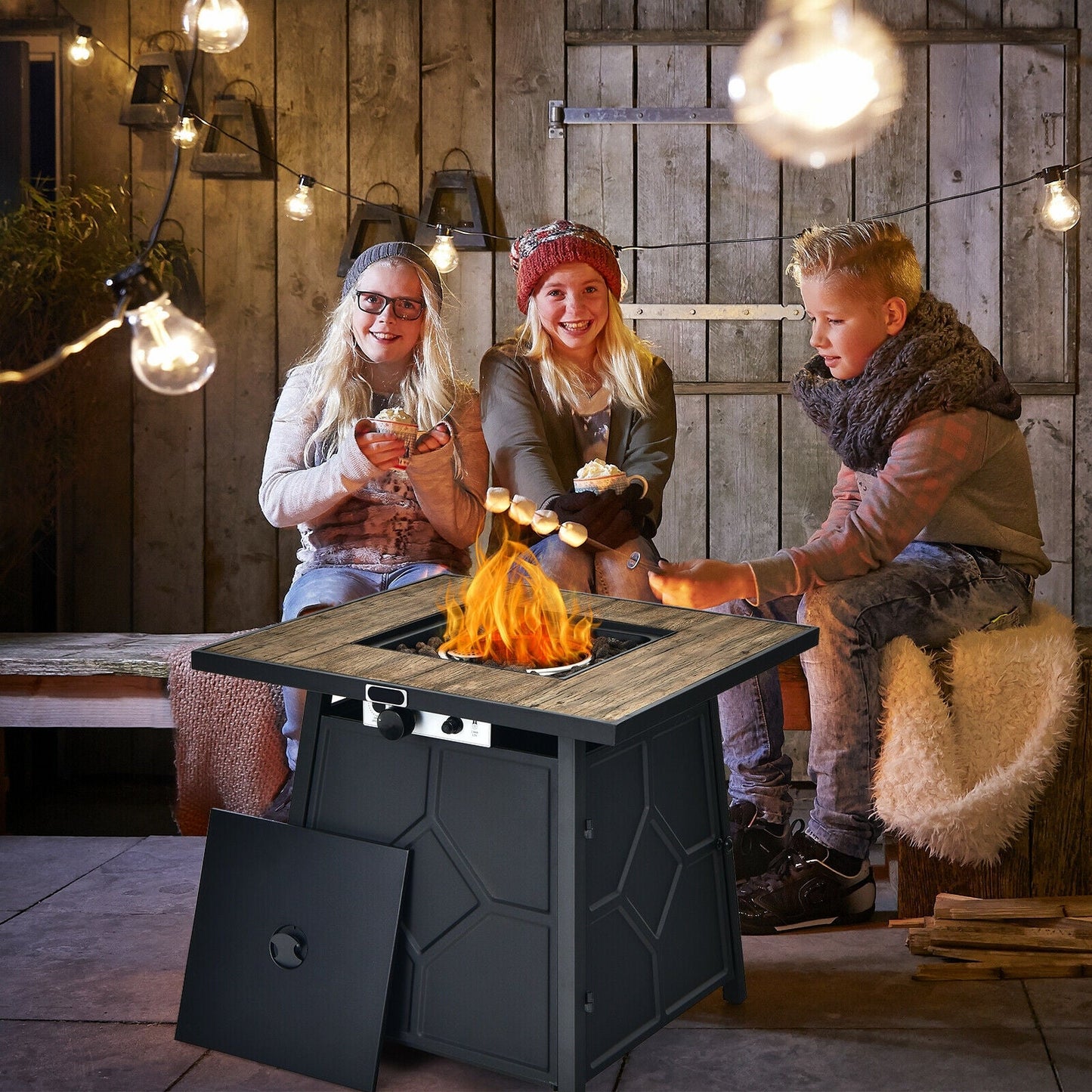 Children enjoying marshmallows around 40 000 BTU 28 Inches Propane Gas Fire Pit Table With Cover at outdoor gathering.