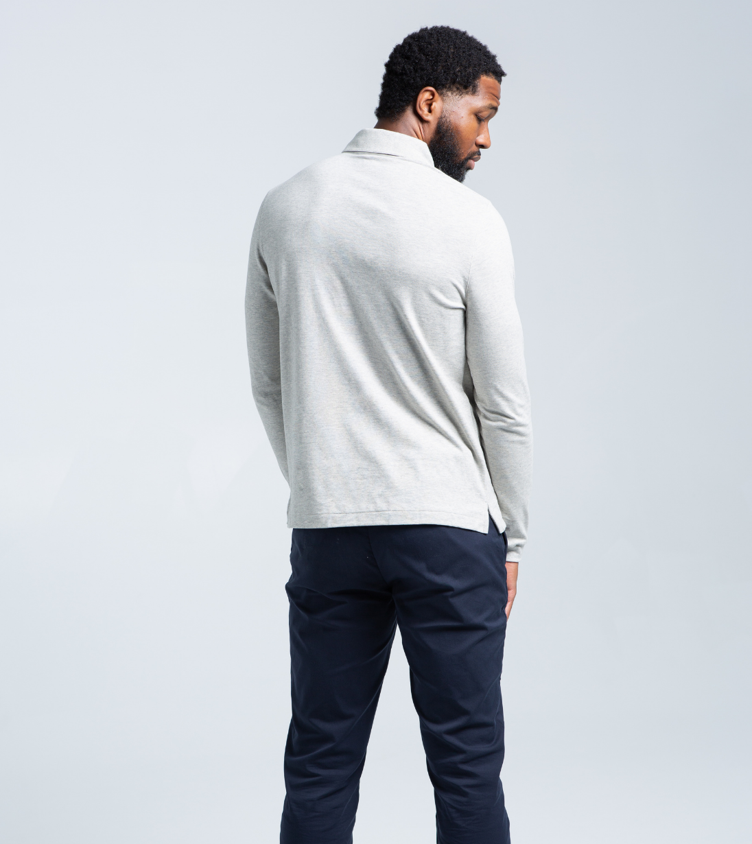 Man wearing Long Sleeve Perfect Polo in light grey, showing tailored fit and modern style from the back view.