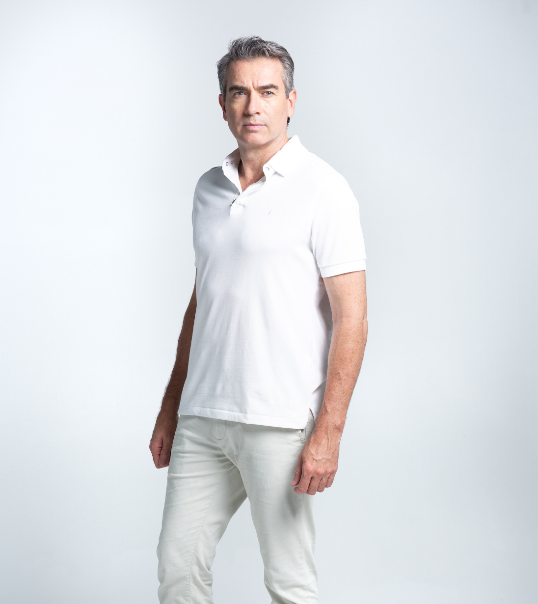 Man wearing Short Sleeve Perfect Polo in white, showcasing wrinkle-free, fade-resistant fabric with a crisp StaySharp™ Collar.