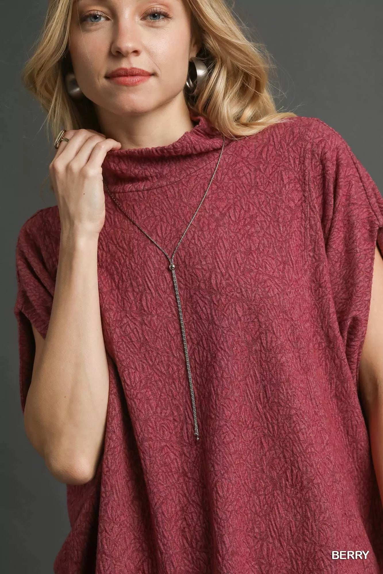 Umgee Textured Mock Neck Relaxed Top in berry with elegant dolman sleeves and mock neck design for stylish everyday wear.