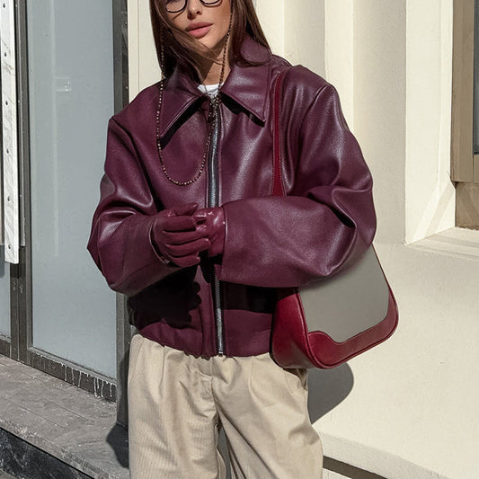 Woman wearing Vintage Style Women's Solid Color Faux Leather Jacket in urban setting.