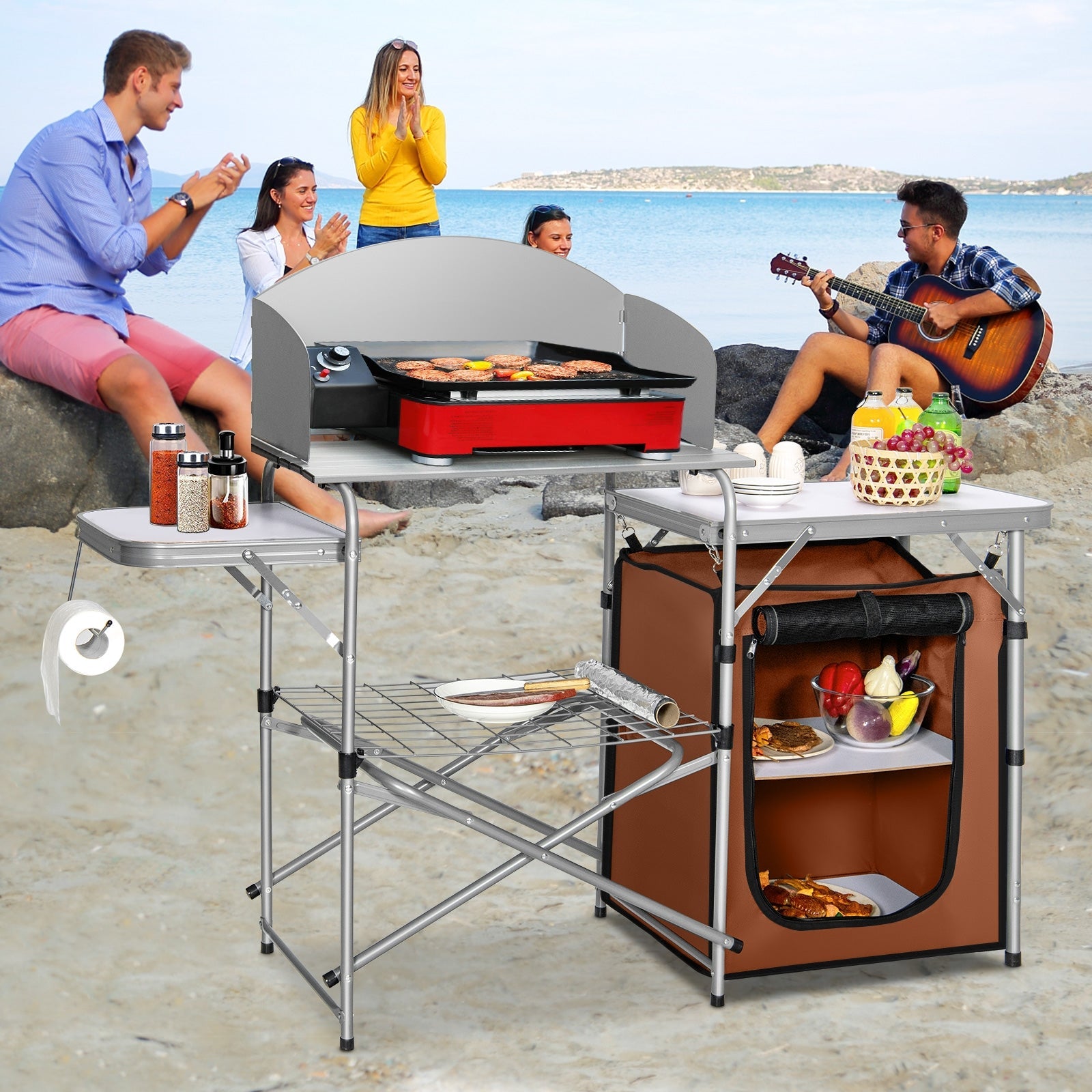 Foldable Outdoor BBQ Portable Grilling Table With Windscreen Bag on beach with people enjoying and barbecuing food