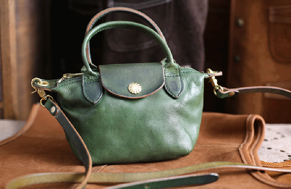 Vintage Luxe Horse Skin Leather Handbag in green with antique silver-tone hardware on leather surface.